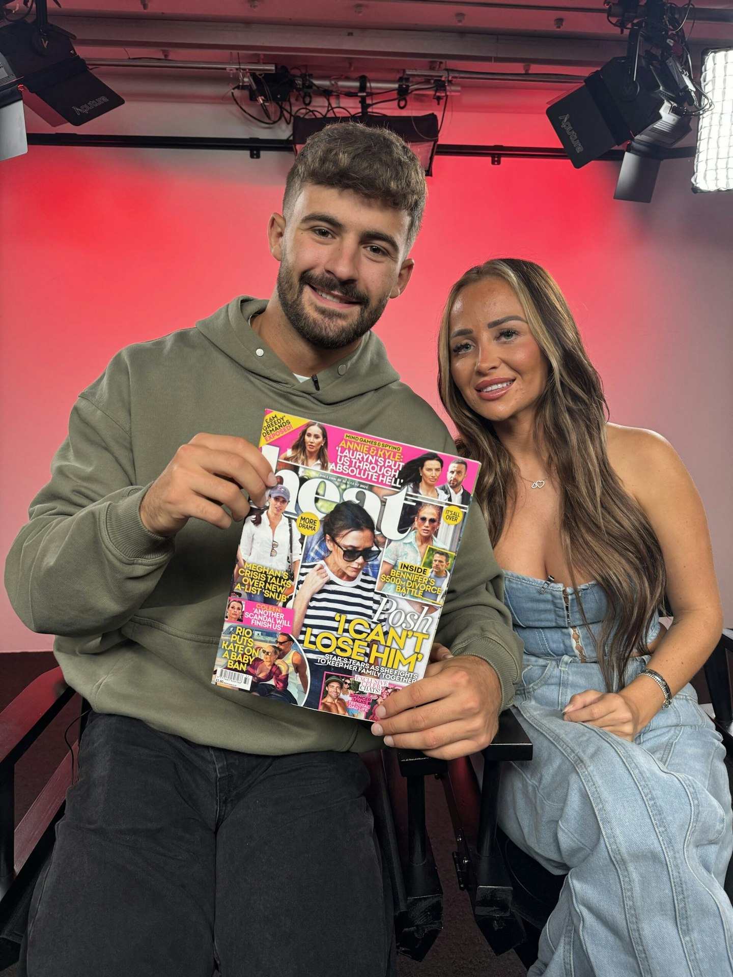 Ciaran Davies and Nicole Samuel holding a copy of heat magazine