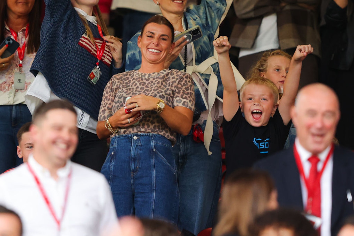 Coleen Rooney, wife of Wayne Rooney, watches on with their children during the Manchester United Foundation charity match between Manchester United Legends and Celtic Legends at Old Trafford