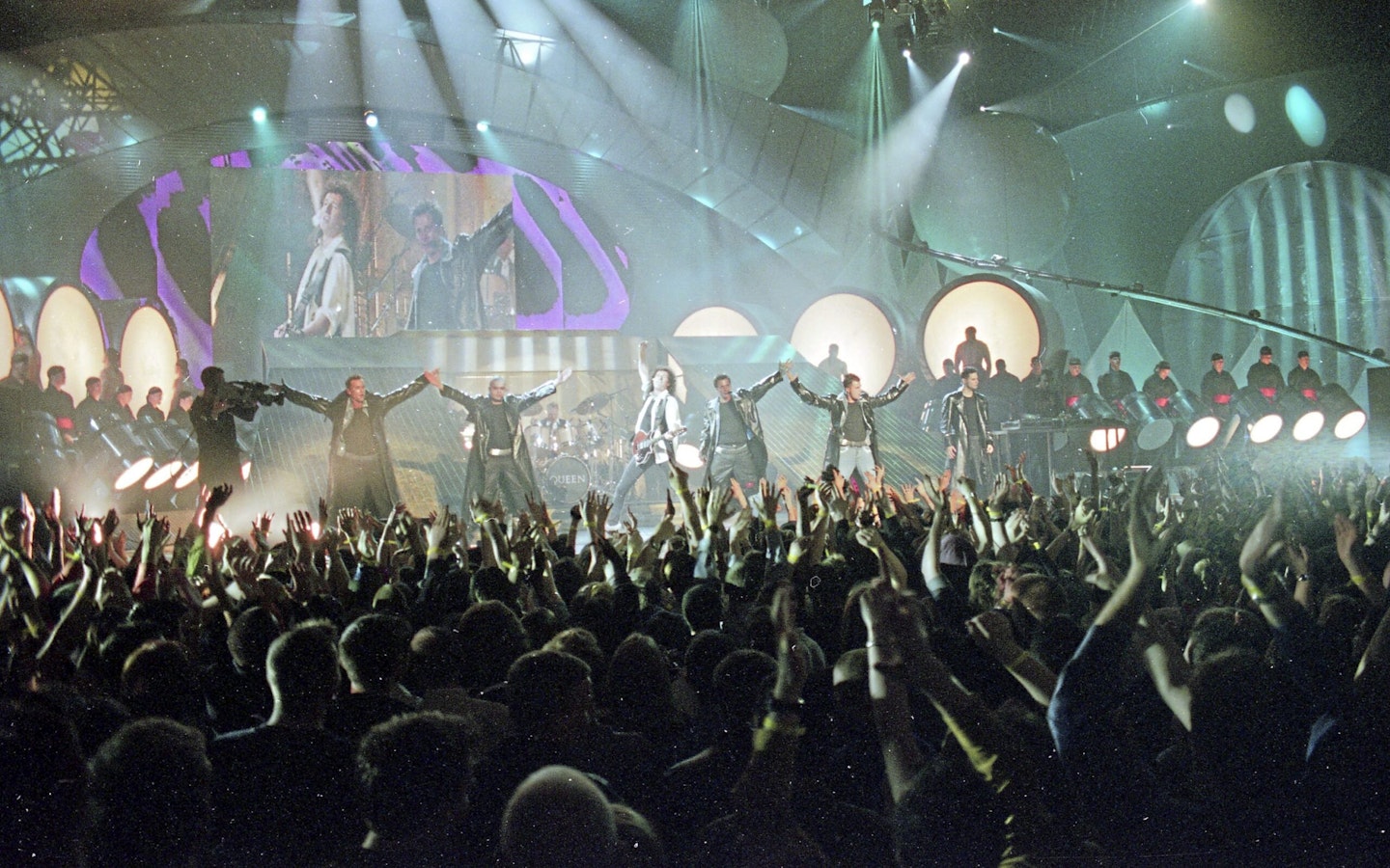 Five performing with Queen