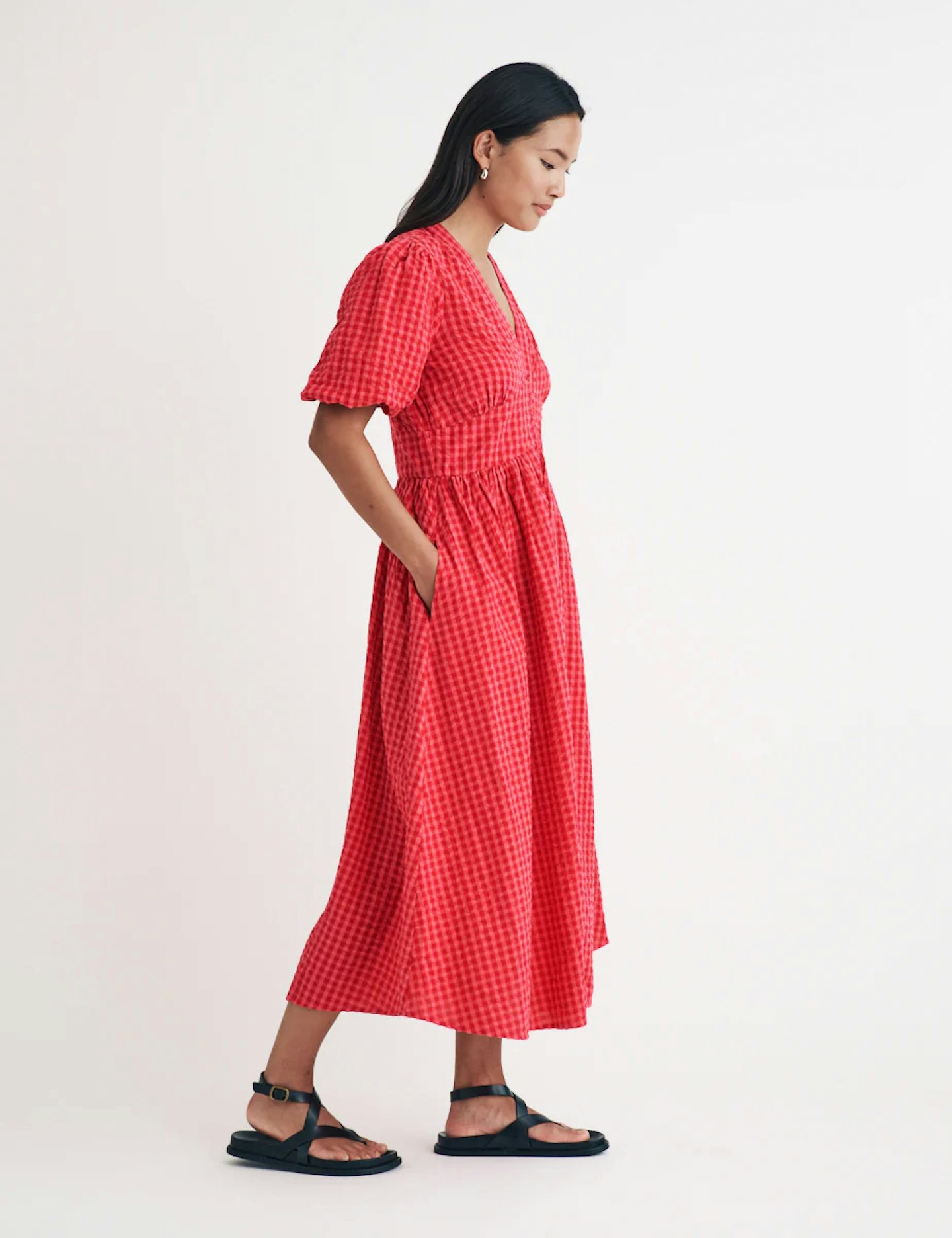 Model wearing Nobody's Child Starlight dress in pink and red gingham