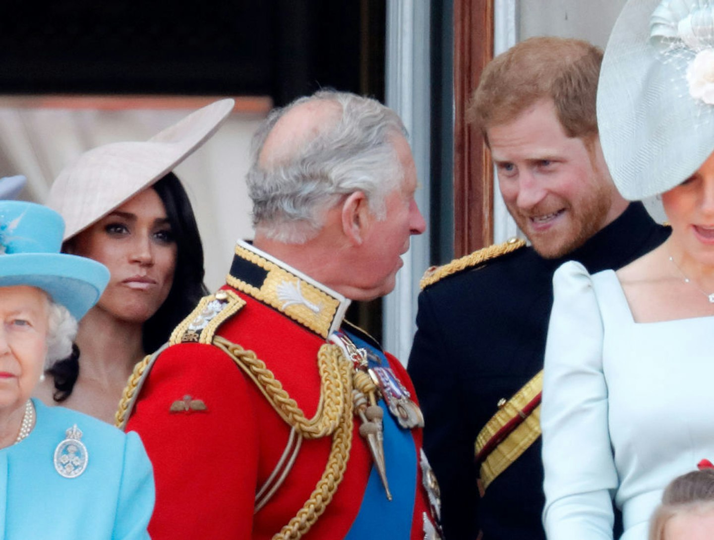 Meghan, Duchess of Sussex, Prince Charles, Prince of Wales and Prince Harry, Duke of Sussex stand on the balcony of Buckingham Palace during Trooping The Colour 2018