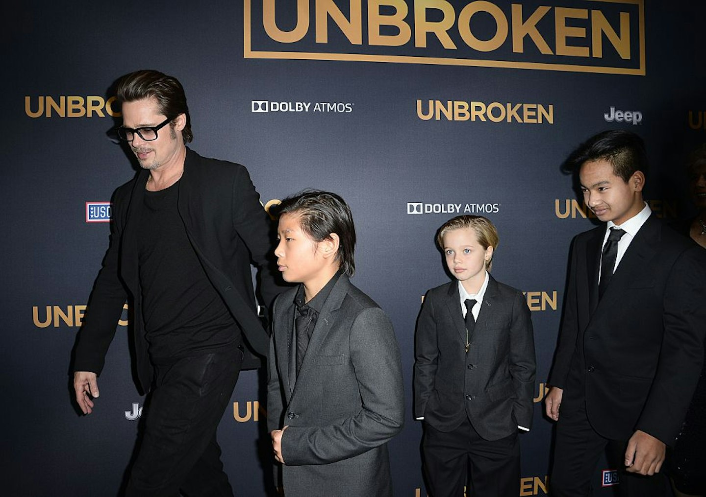 Actor Brad Pitt and children Pax Jolie-Pitt (L), Shiloh Jolie-Pitt (C) and Maddox Jolie-Pitt arrive for the U.S. premiere of Universal Pictures "Unbroken," December 15, 2014 at the Dolby Theatre in Hollywood, California.