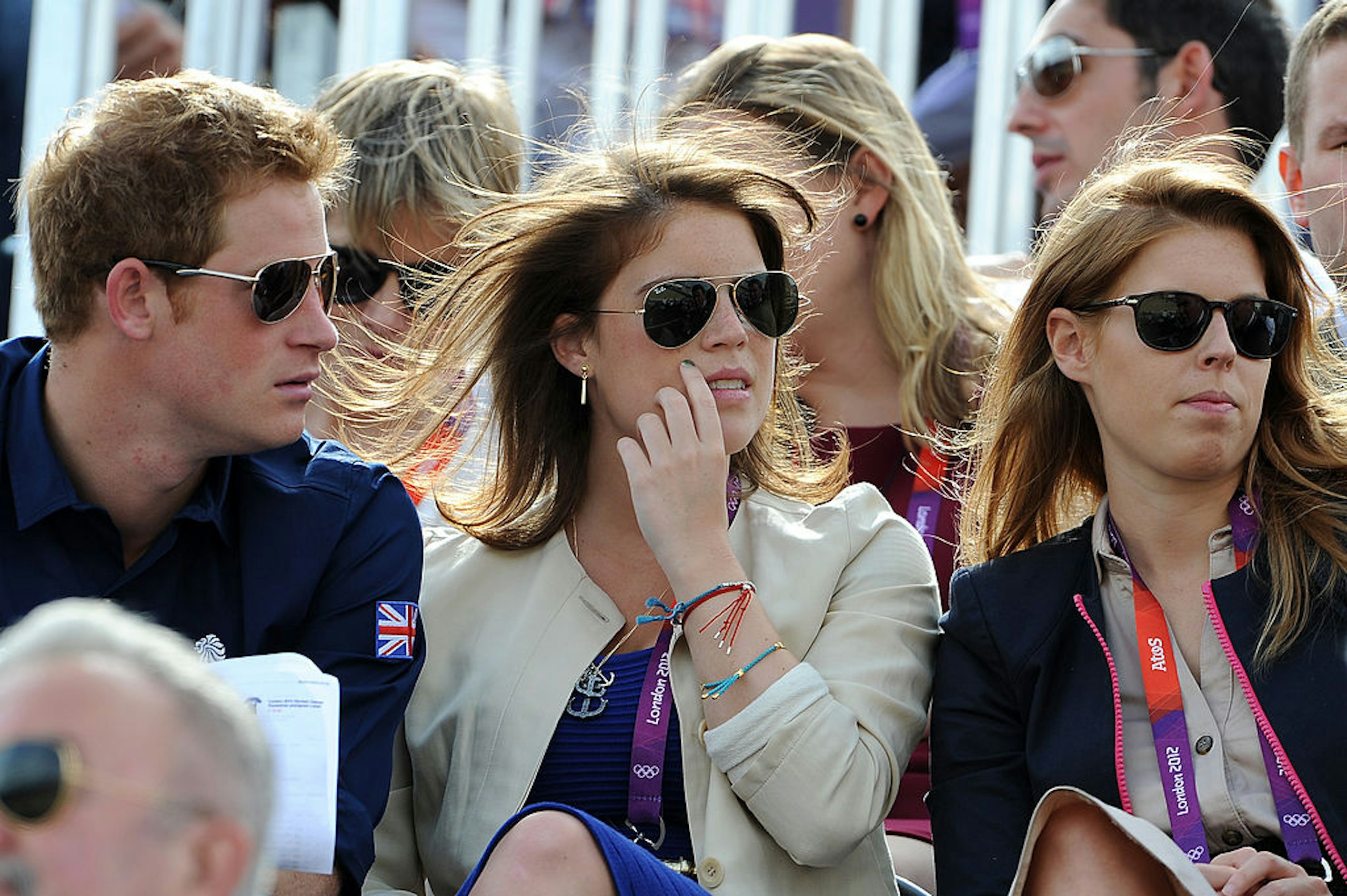 Prince Harry, Princess Eugenie, and Princess Beatrice watch the Eventing Cross Country Equestrian event on Day 3 of the London 2012 Olympic Games