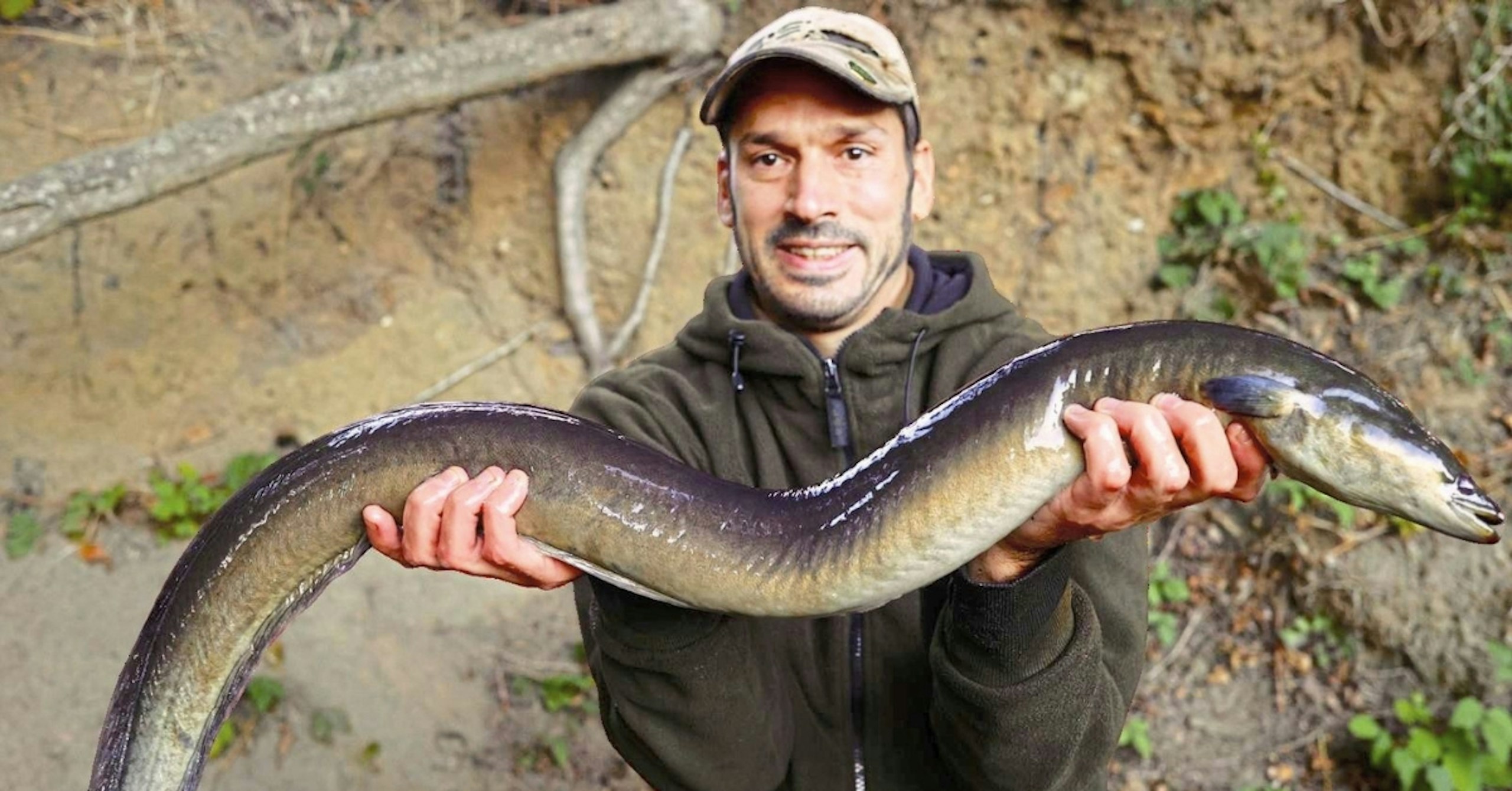 Daniel Woolcott holding a large eel