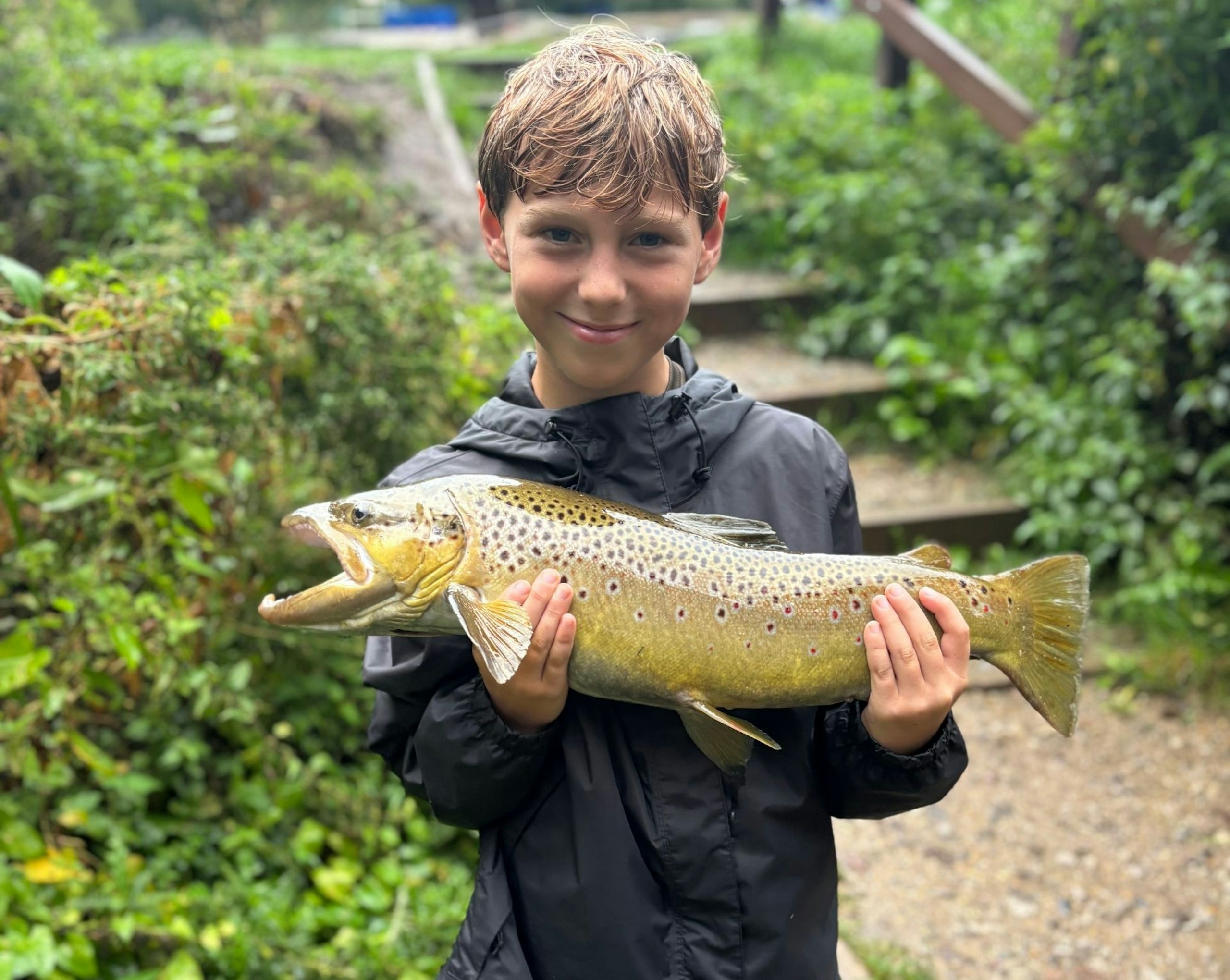 Sebastian Hancock holding a trout
