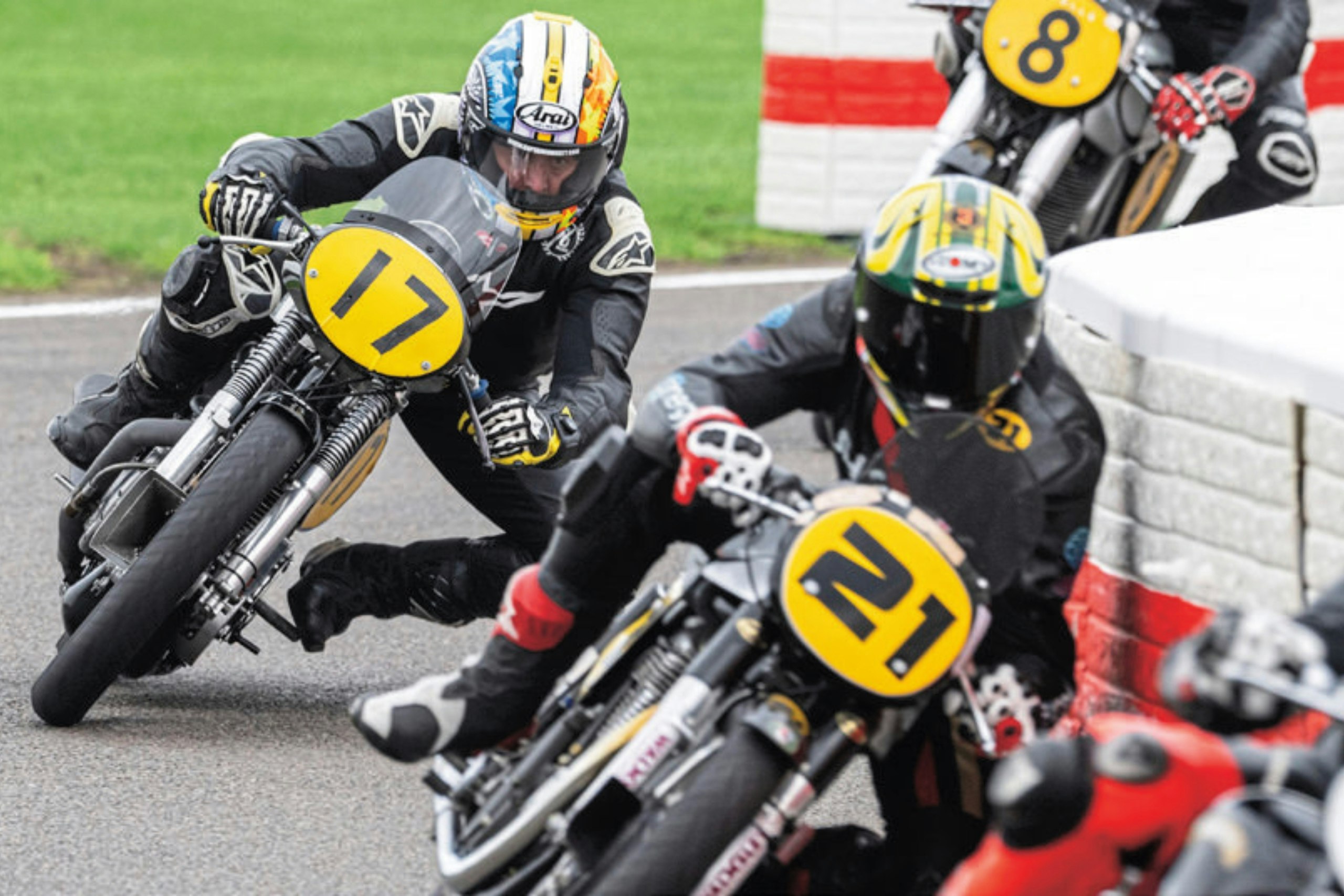 bikers Adam (bike number 17) chases Troy Bayliss (bike number 21) around the track at Goodwood Revival