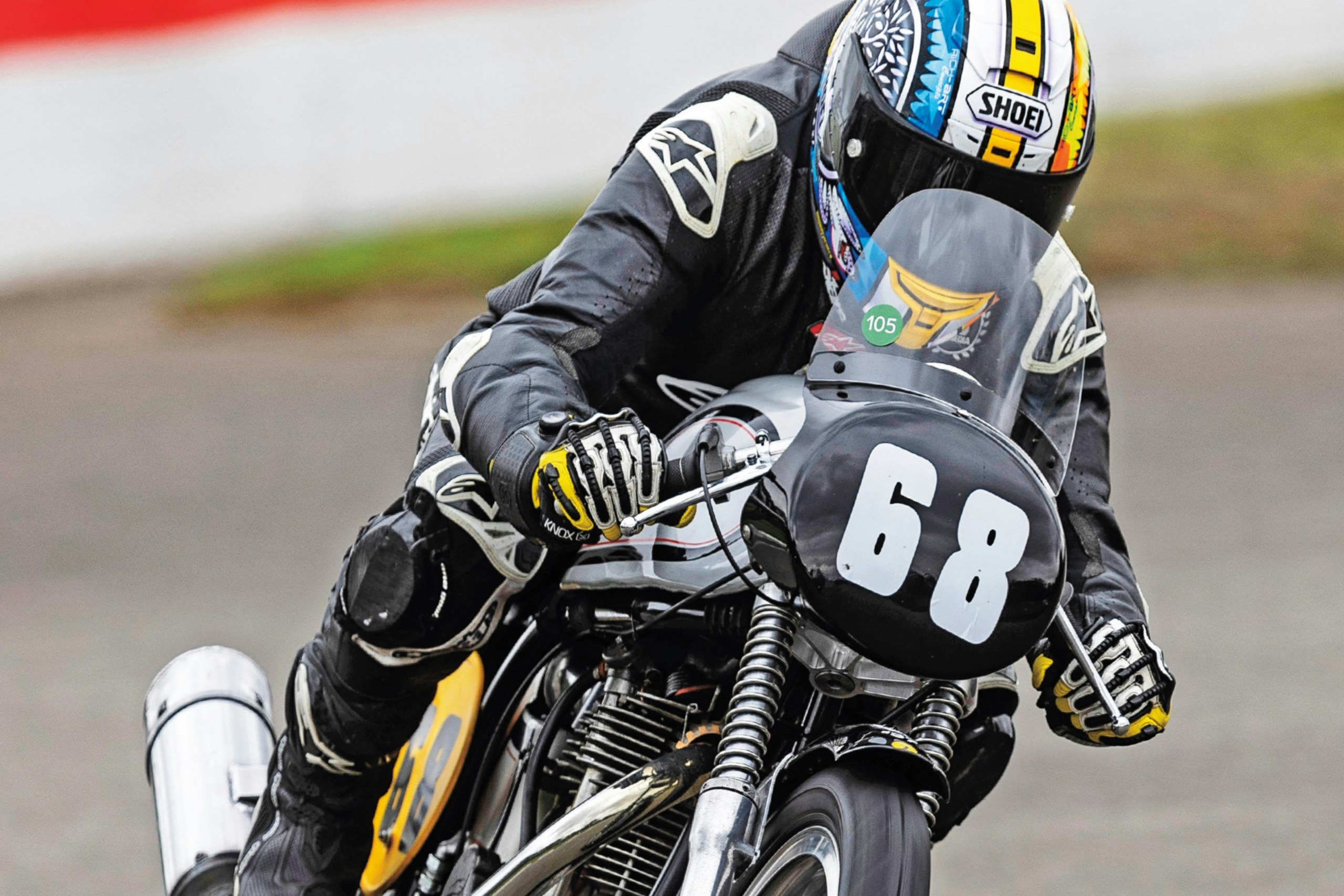 a rider on the view of one wheel on the Manx Norton going around a track