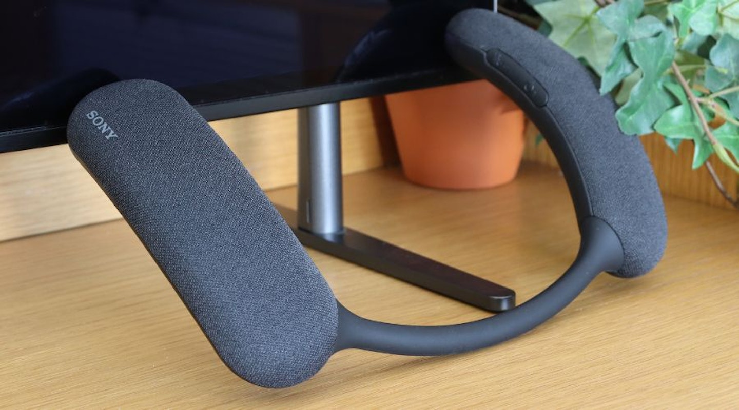 Sony Bravia Theatre U (HT-AN7) Neckband with Dolby Atmos, resting against the Sony BRAVIA 8 TV, next to a green indoor plant
