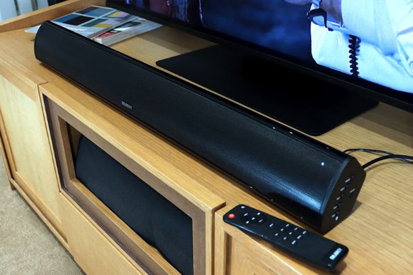 Best soundbar under £100. Majority Teton Plus soundbar and remote on a TV unit. Best budget soundbars.