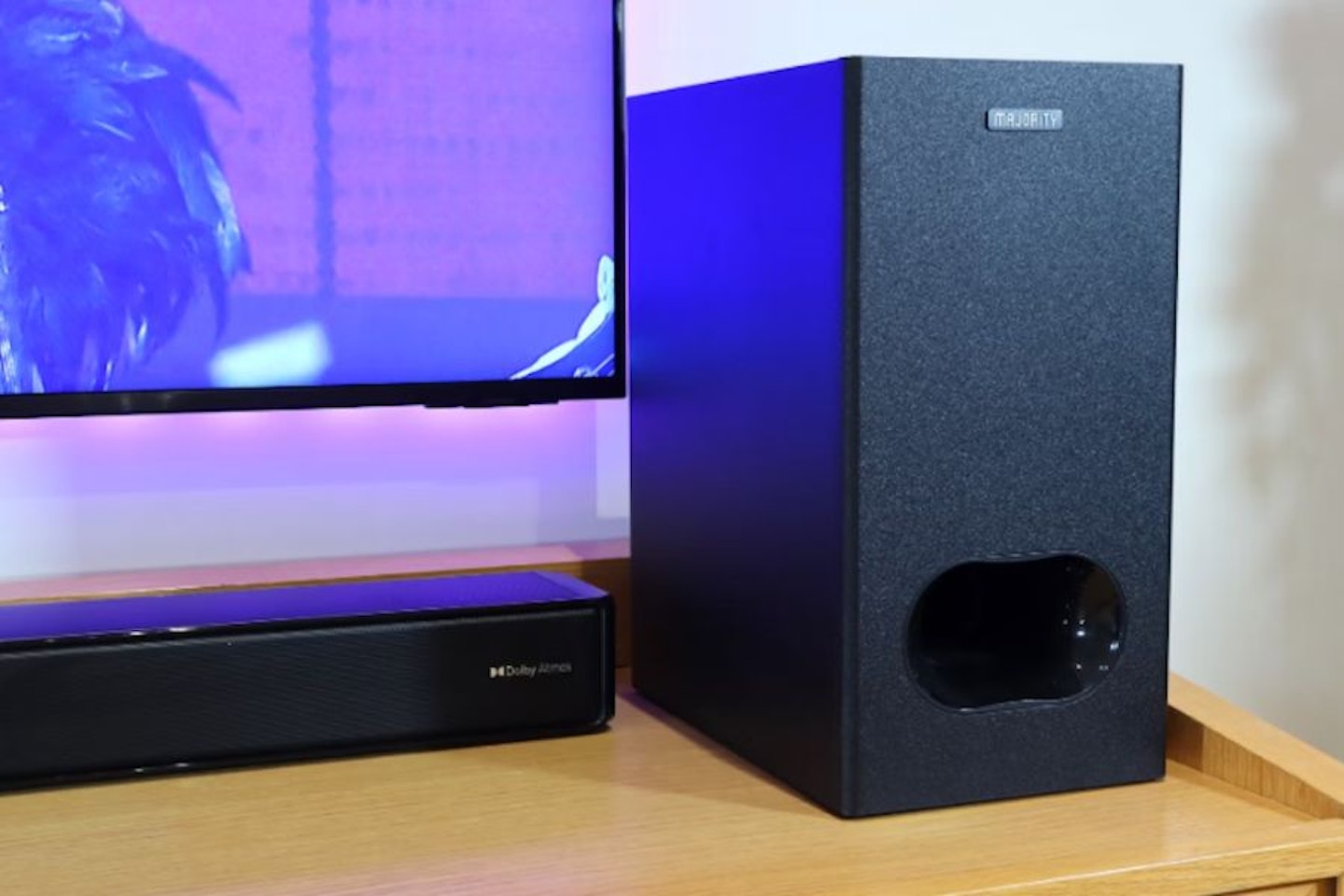 Majority Sierra Plus Dolby Atmos 2.1.2 Soundbar with Wireless Subwoofer next to a TV. Best budget soundbars, the best soundbar under £200.