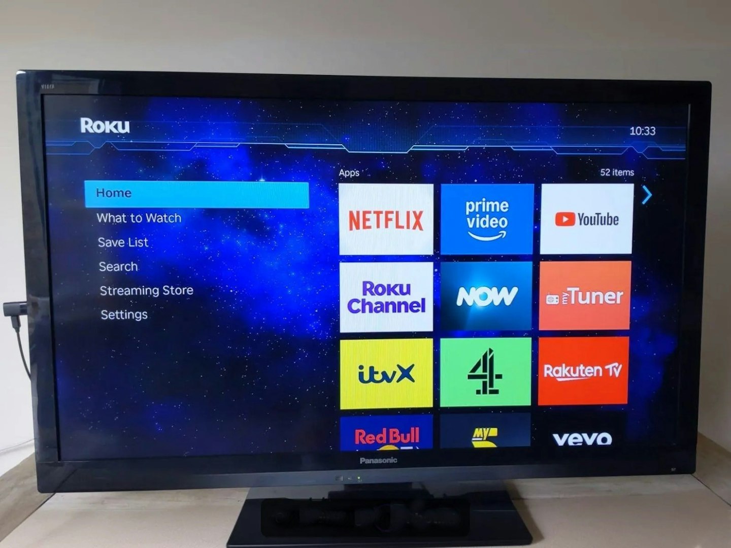 Panasonic TV showing Roku OS interface with apps including Netflix and itvX