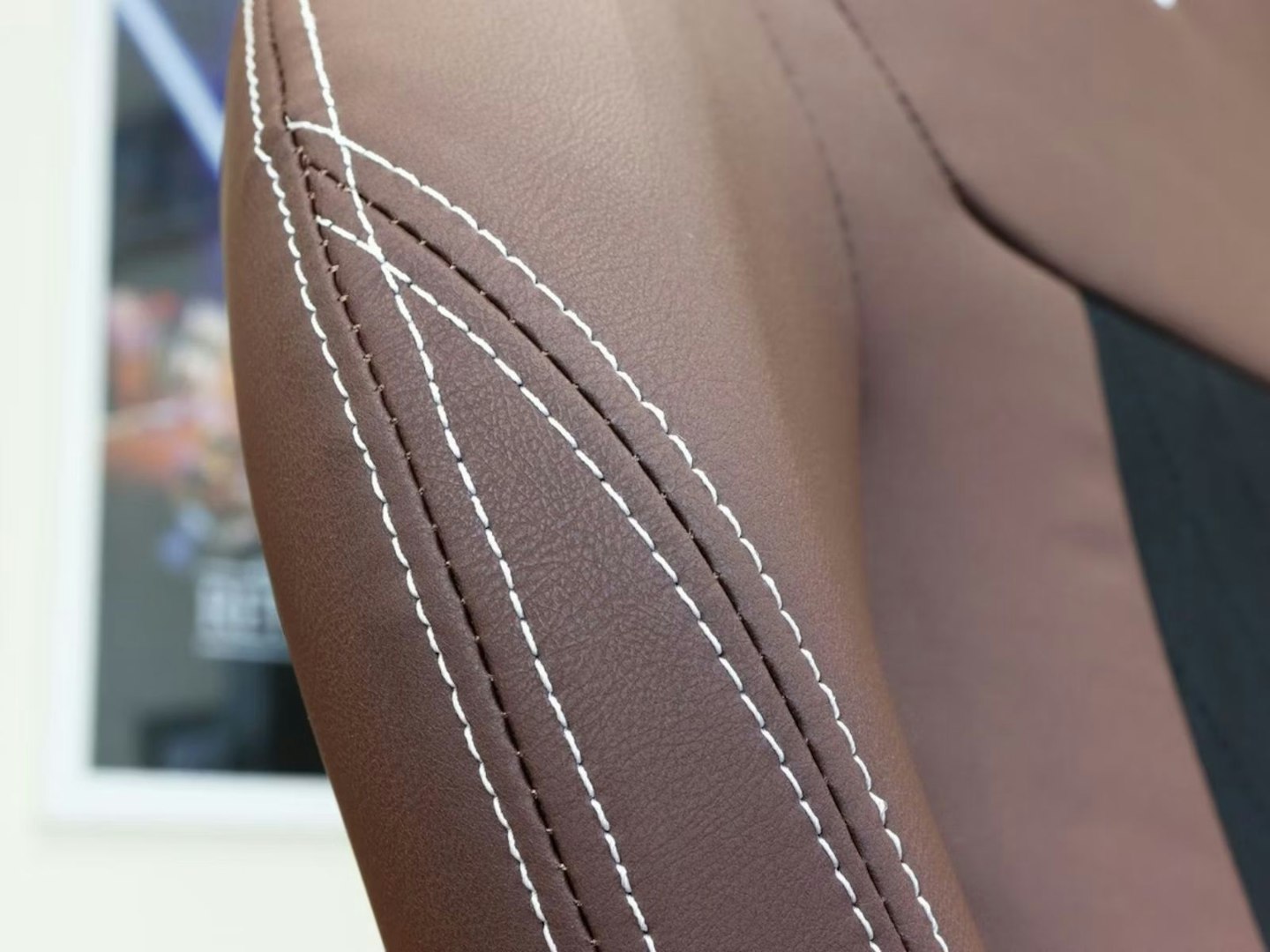 The stitched leather of a gaming chair