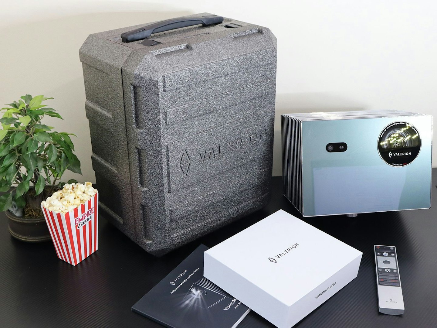 Valerion VisionMaster Pro 2 4K Laser Projector and case on a desk