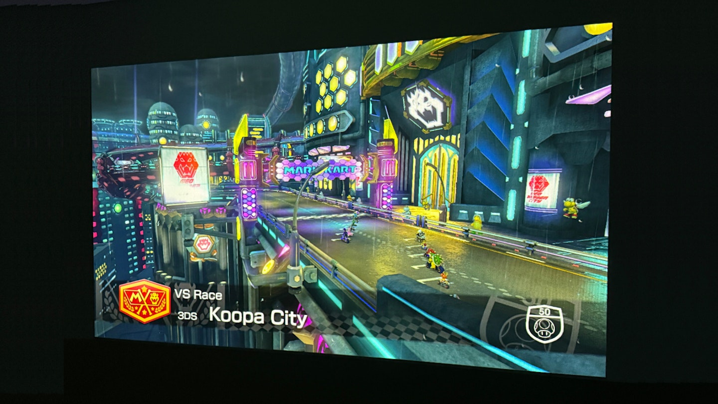 EPSON EF-22N projector casting a Mario Kart 8 Deluxe cutscene via HDMI-connected Nintendo Switch onto a wall.