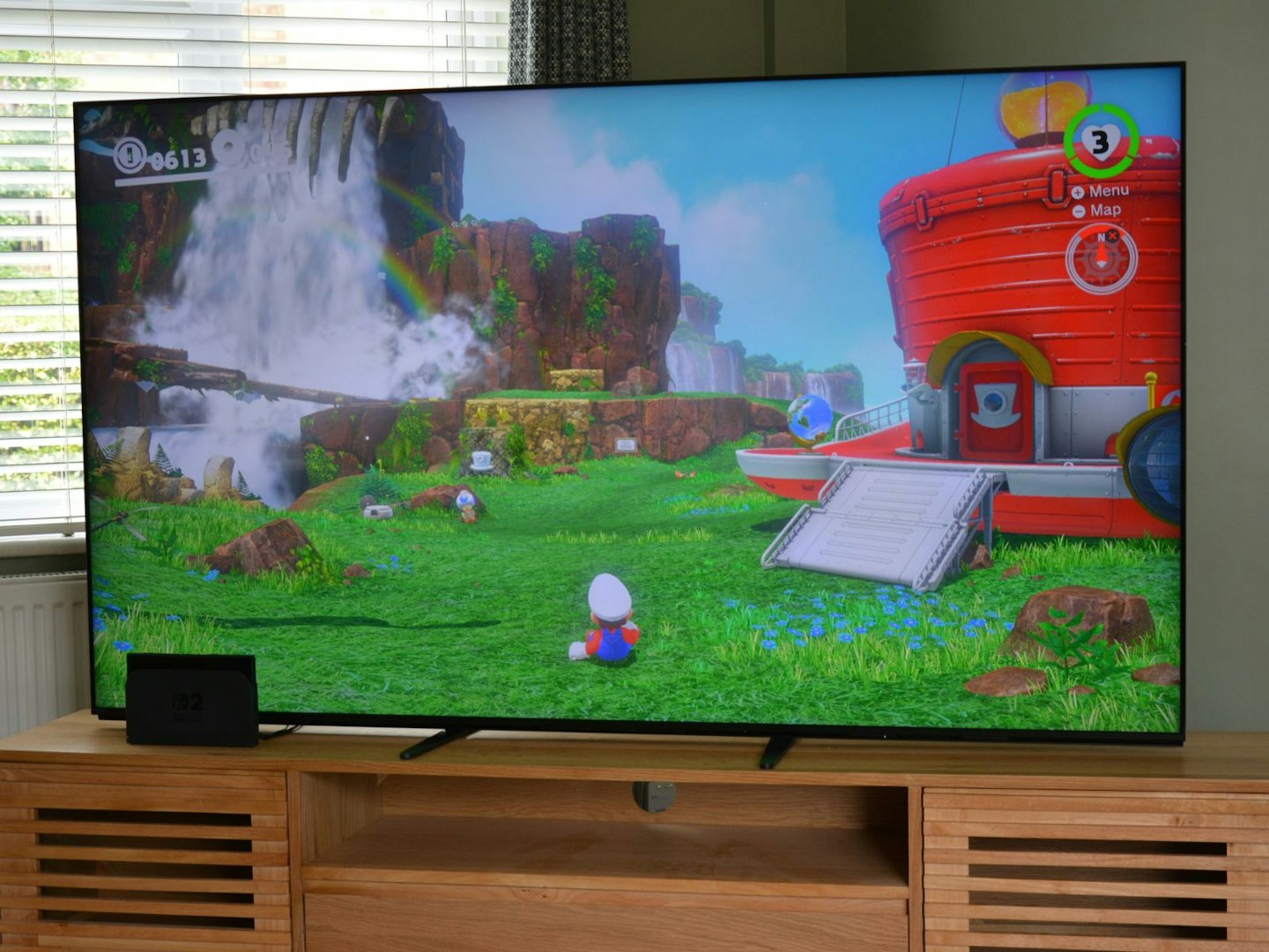 Nintendo Switch 2 docked, connected via HDMI to Sony BRAVIA 9 75-inch 4K 120Hz TV showing Mario Odyssey gameplay – Mario in Cascade Kingdom with new free Switch 2 upgrade featuring enhanced visual