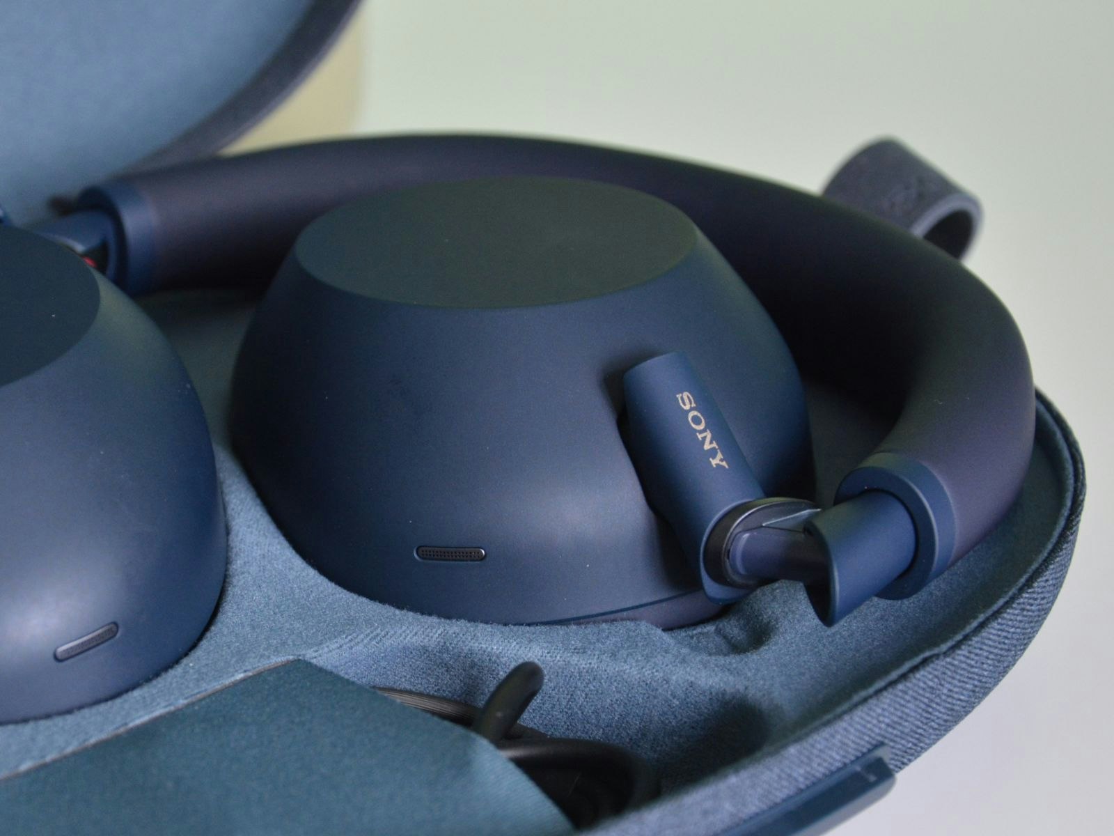 Sony WH-1000XM6, one of 2025’s best surround sound headphones, shown folded inside its sleek travel case