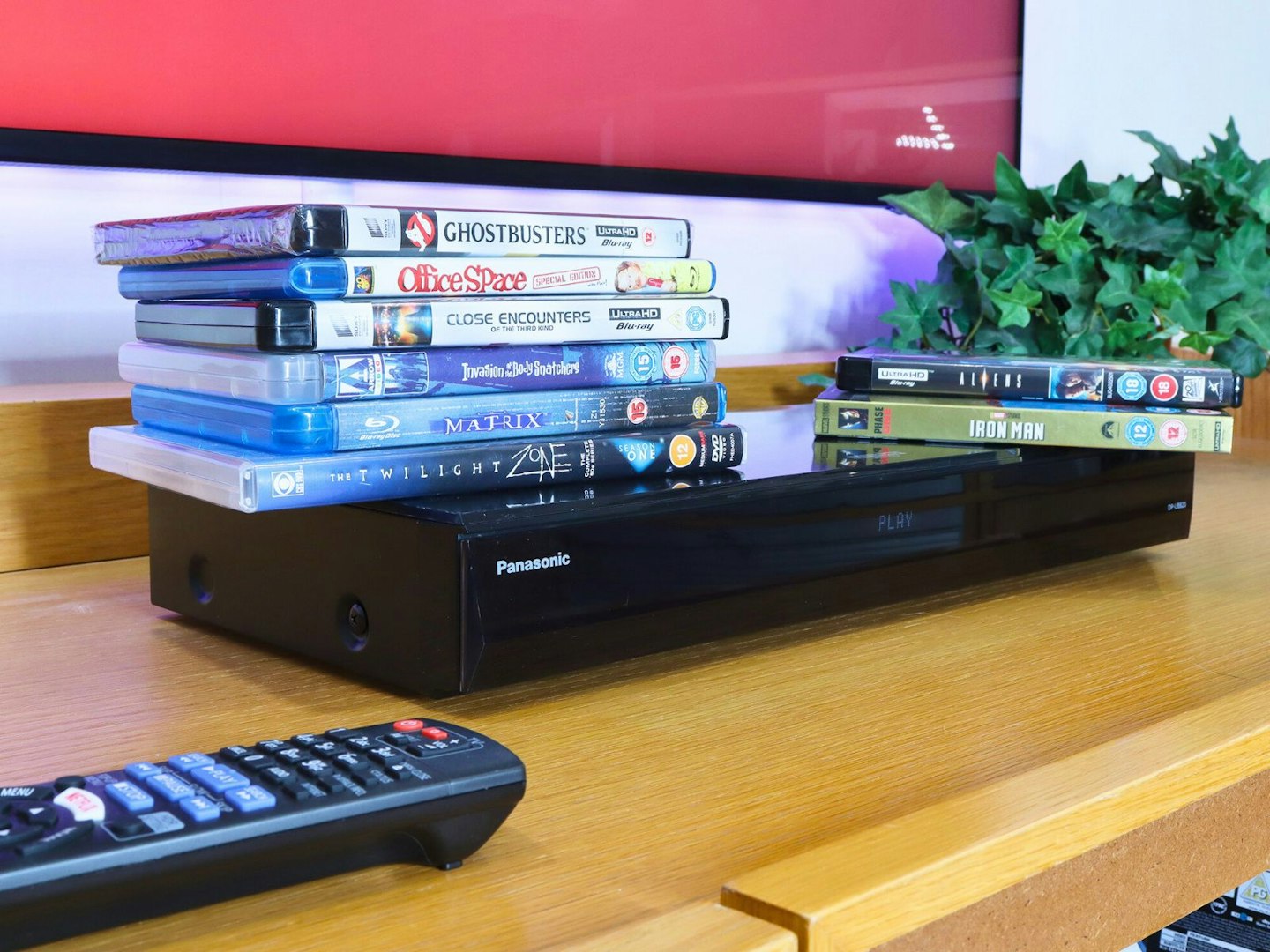 Panasonic DP-UB820EB Blu-ray Player - with a piule od movie cases on top