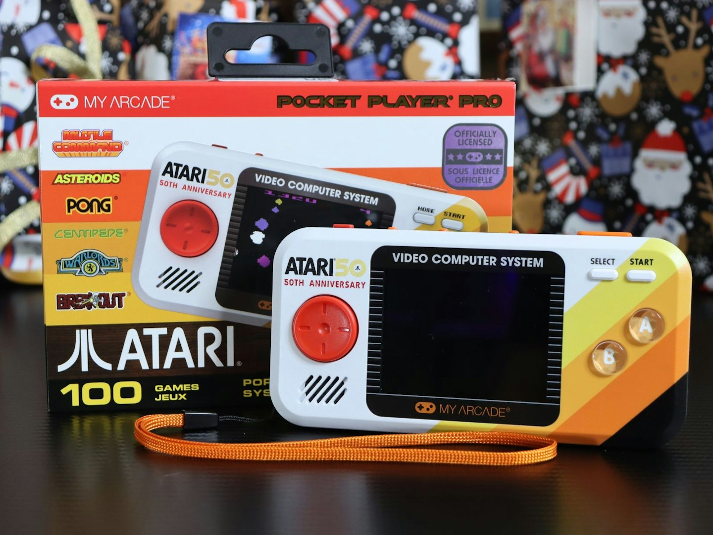 My Arcade Atari Pocket Player Pro Handheld Portable Gaming System with box on a desk with presents behind