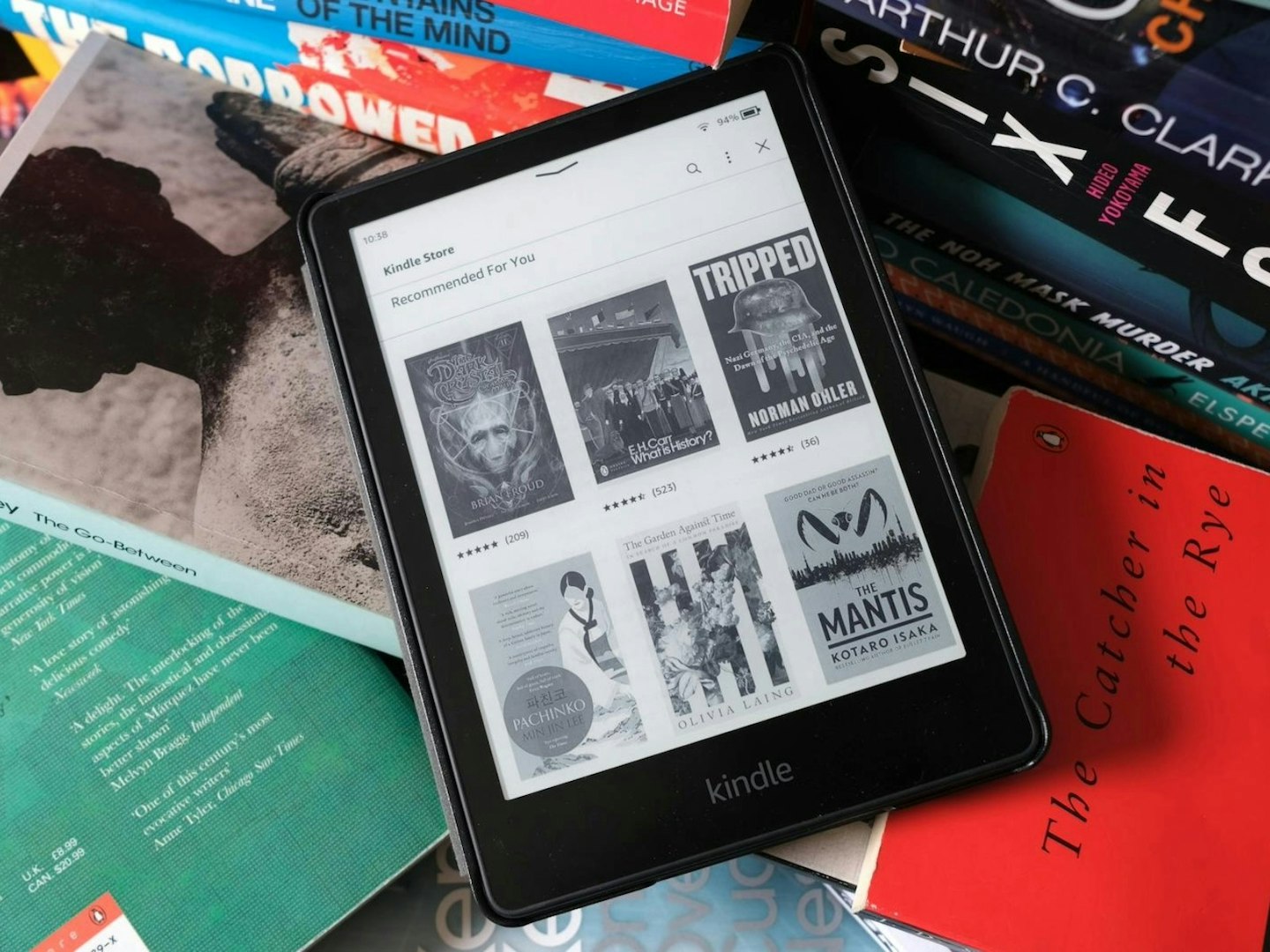 Kindle Paperwhite on and near paperback books. Best tech gifts for Christmas.