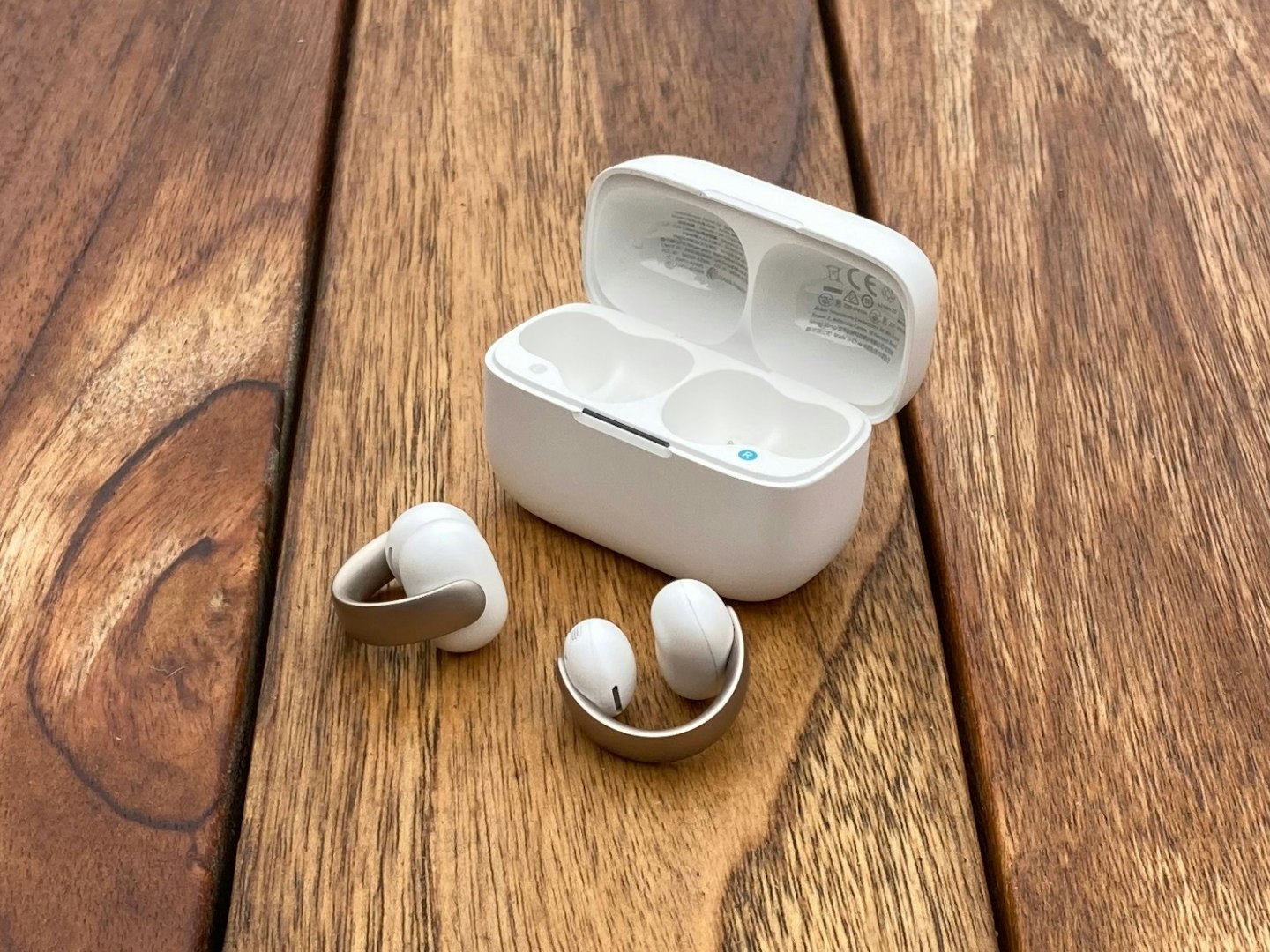 soundcore AeroClip open ear earbuds with charging case on table. Best tech gifts.