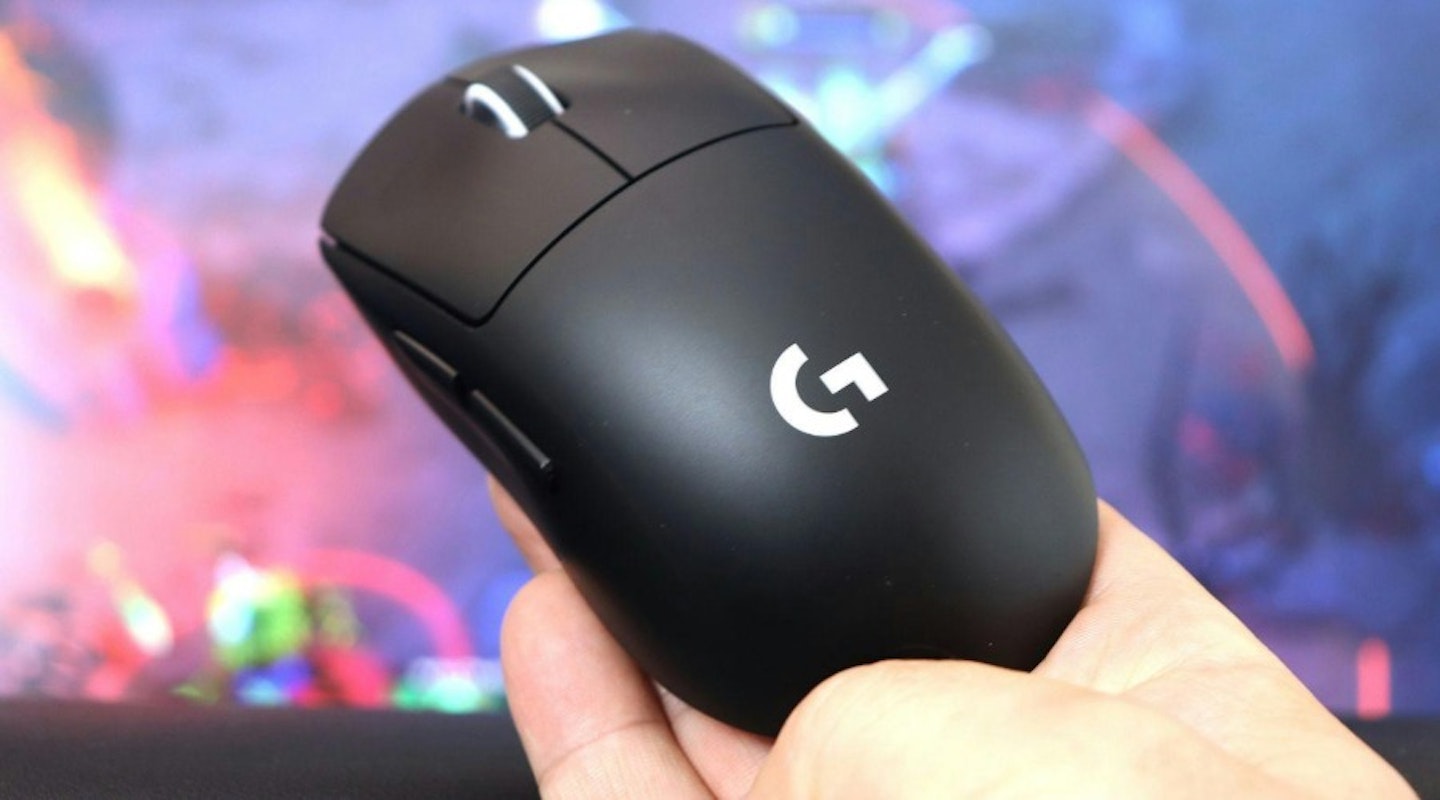 Logitech G Pro X Superlight 2 Gaming Mouse held in hand in front of monitor. The best tech gifts of 2025.