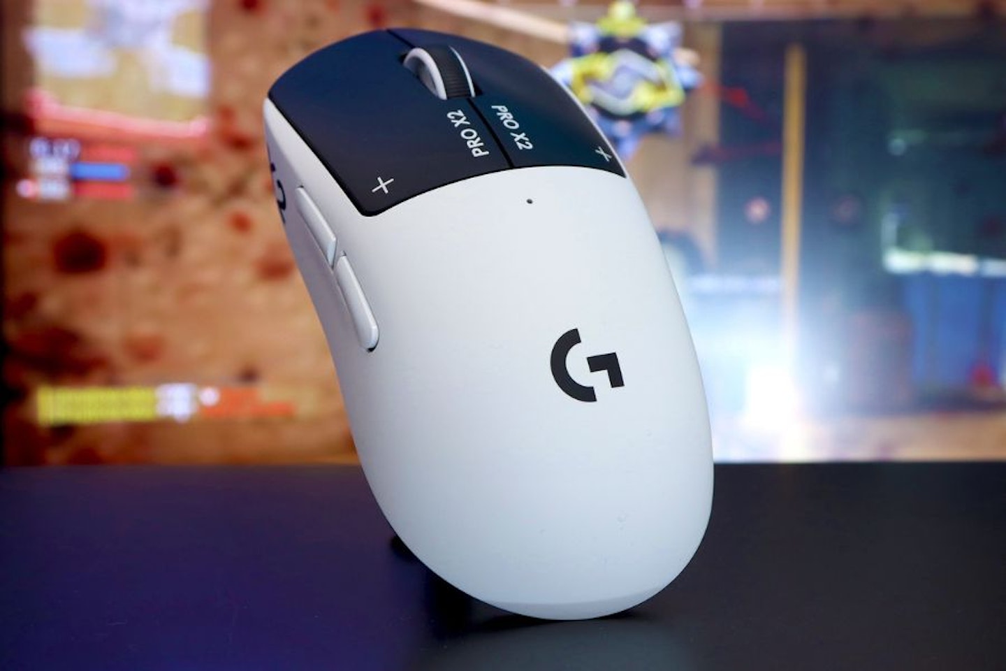 Logitech PRO X2 SUPERSTRIKE Gaming Mouse - top view in front of game