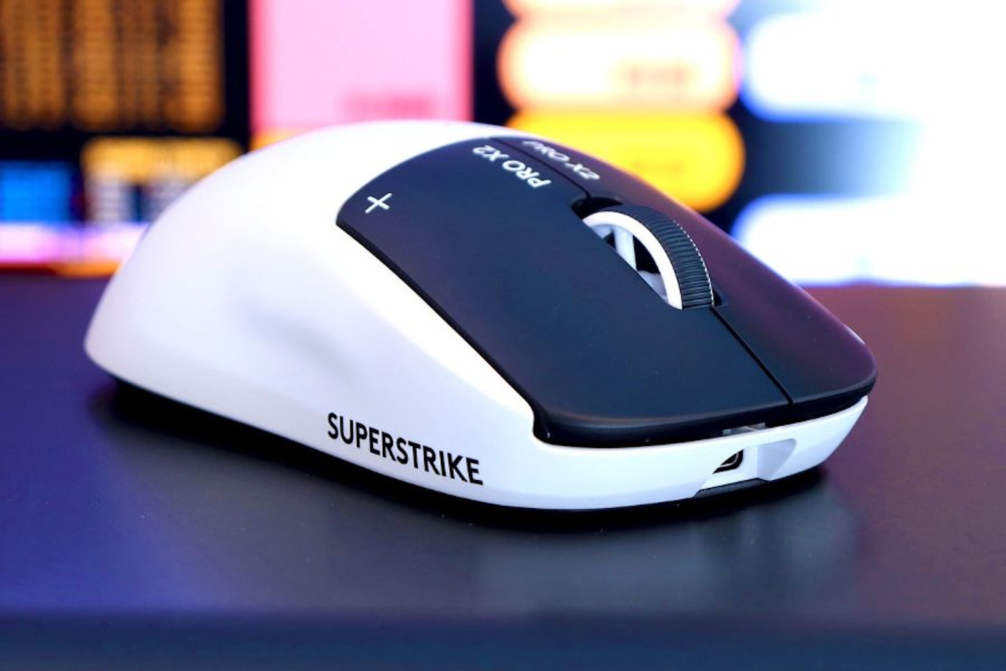 Logitech PRO X2 SUPERSTRIKE Gaming Mouse - in front of a game monitor