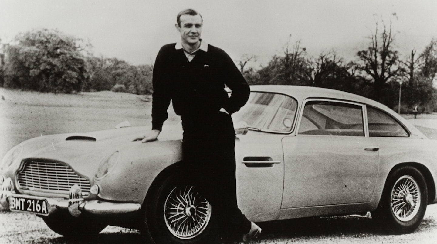 Sean Connery posing with the Aston Martin DB5