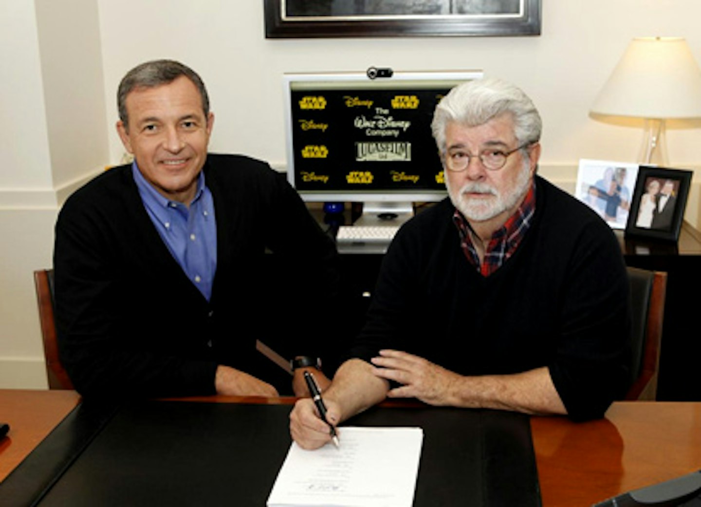 Robert A. Iger, chairman and CEO, The Walt Disney Company, and George Lucas, chairman and founder, Lucasfilm sign the agreement for The Walt Disney Company to acquire Lucasfilm Ltd.