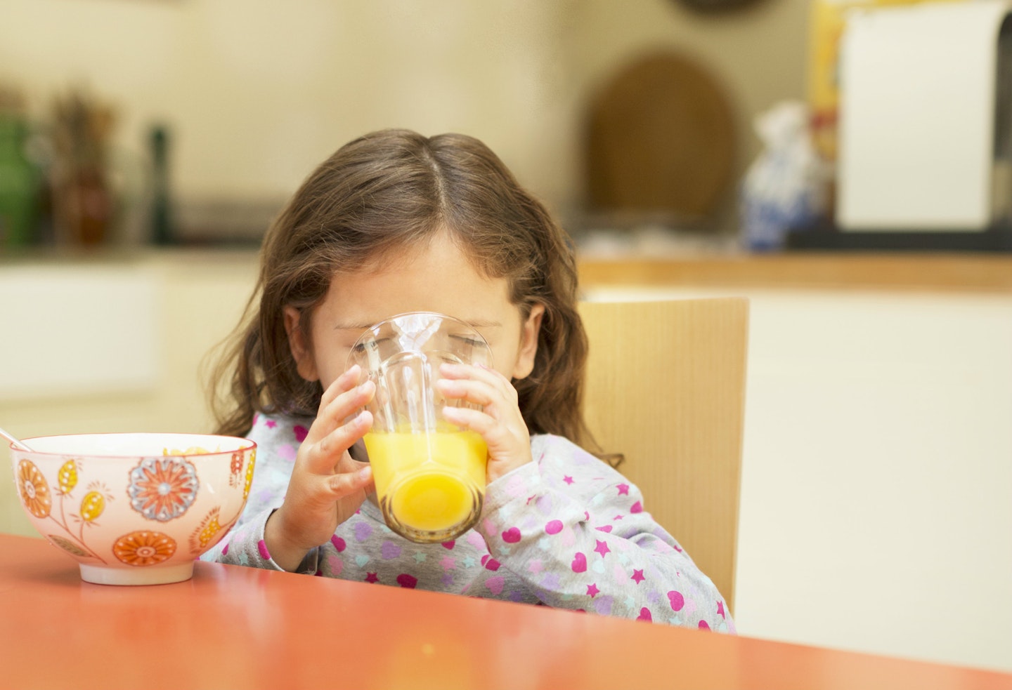 kid drinking orange juice 