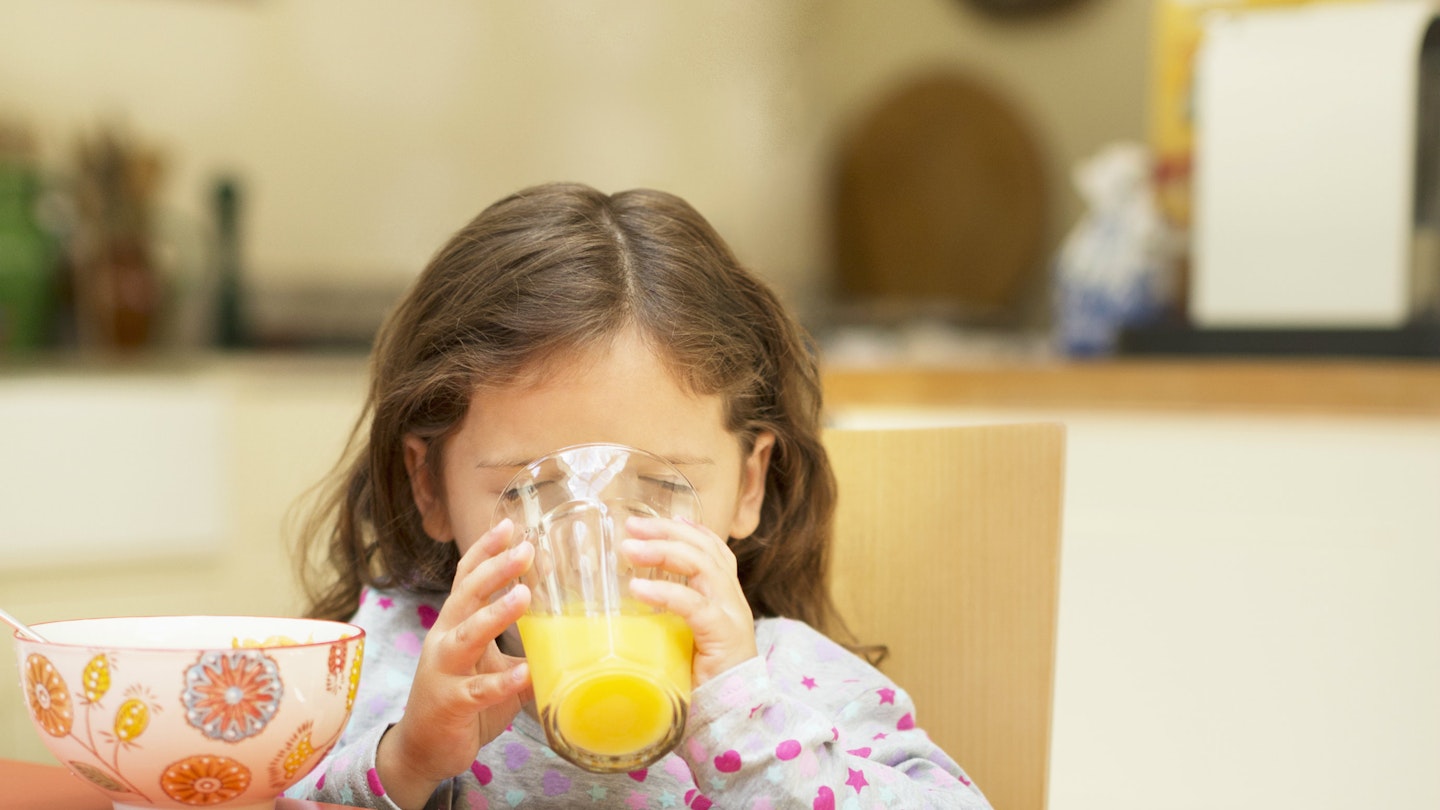 kid drinking orange juice 