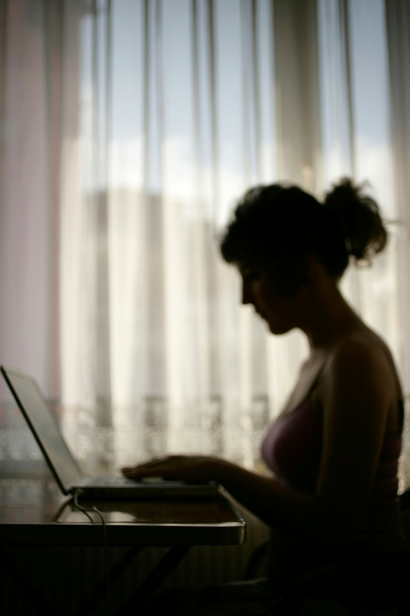 woman typing laptop dark 