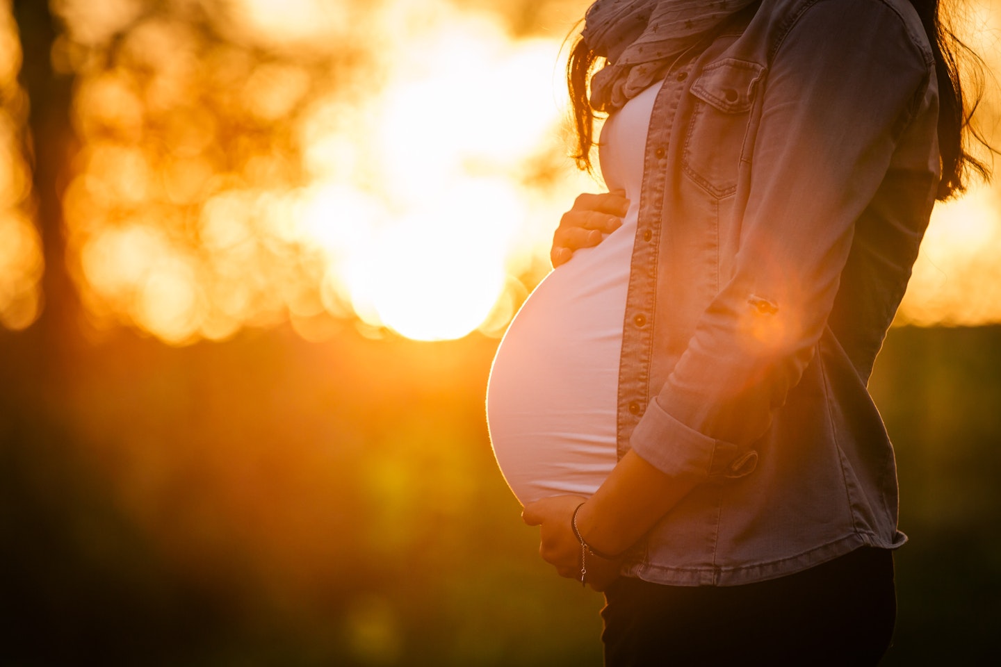 pregnant woman bump sunset 