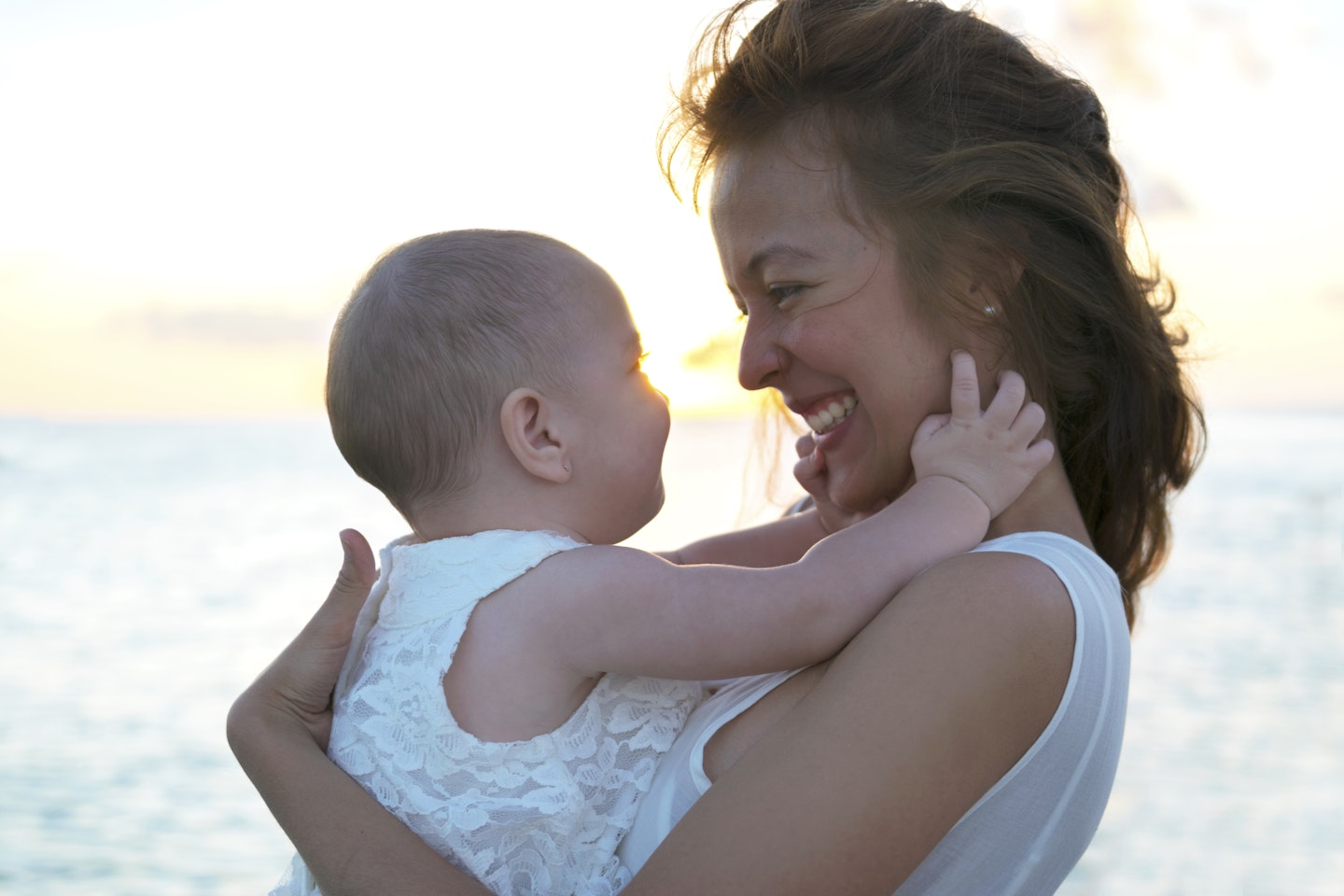 Mother smiling down at baby girl