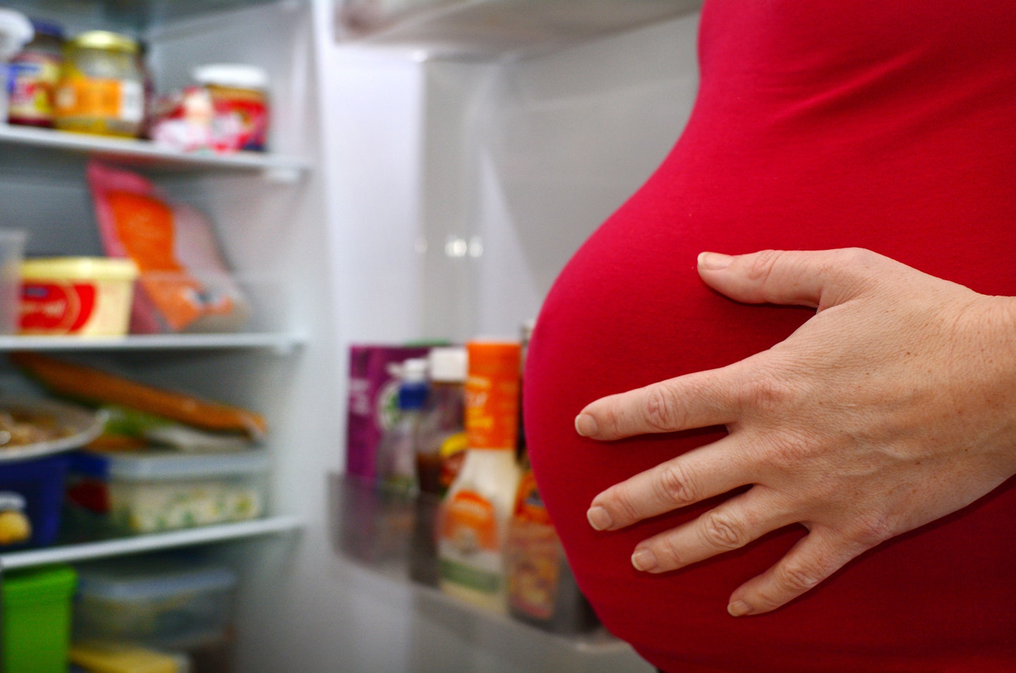pregnancy cravings pregnant woman by fridge