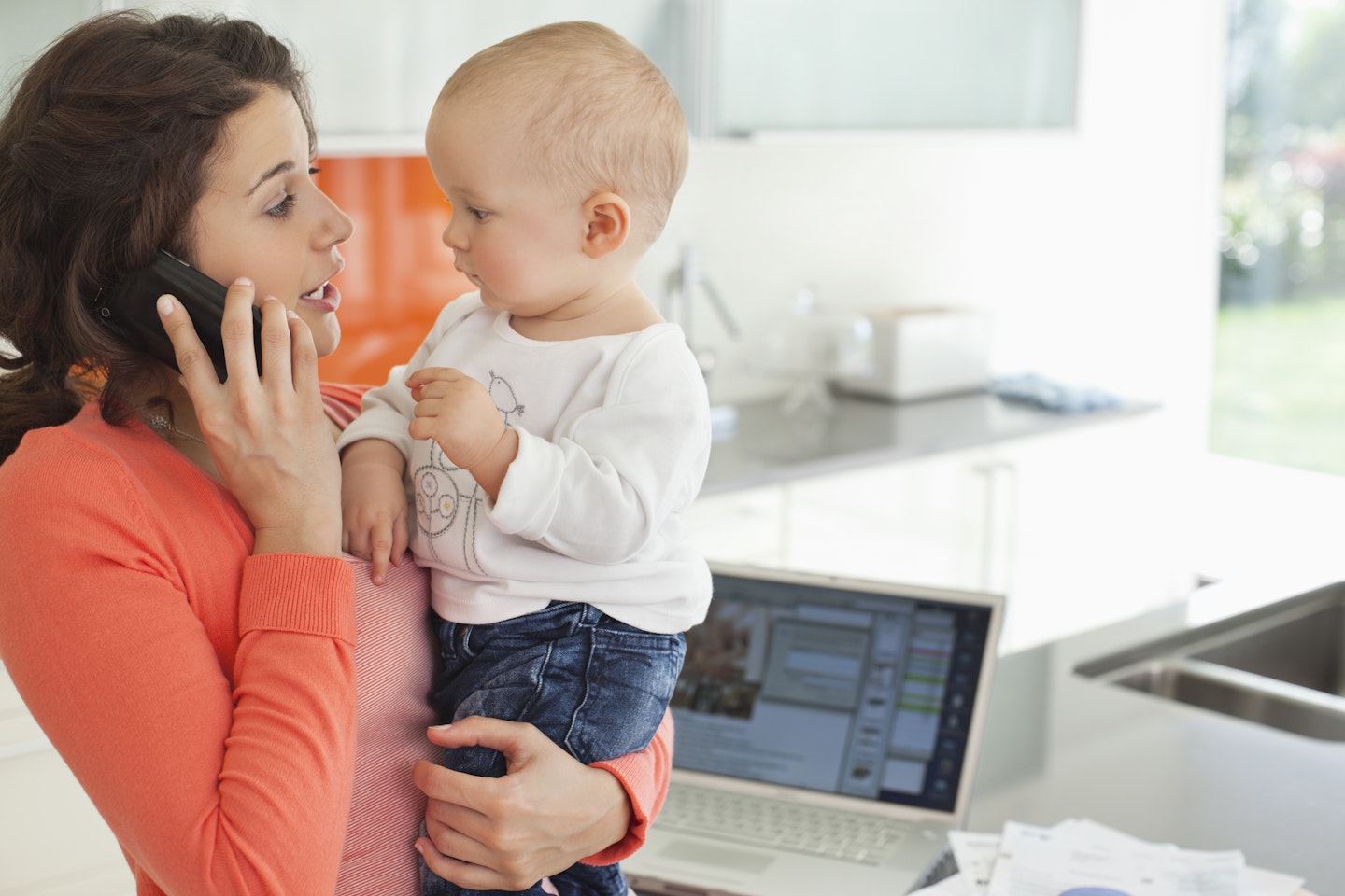 Holding baby to left