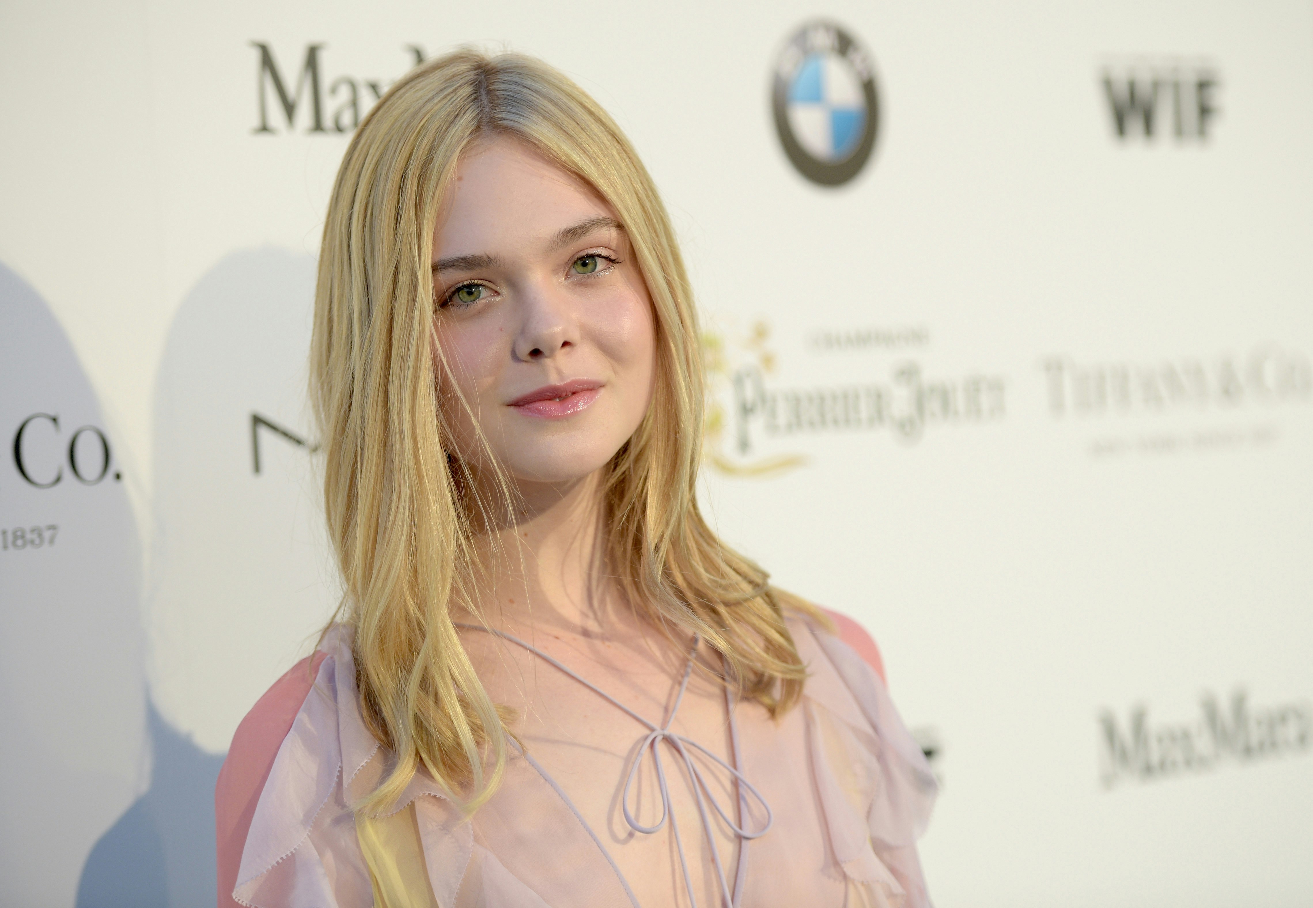 Elle Fanning shows off her perfectly skin as she poses in a