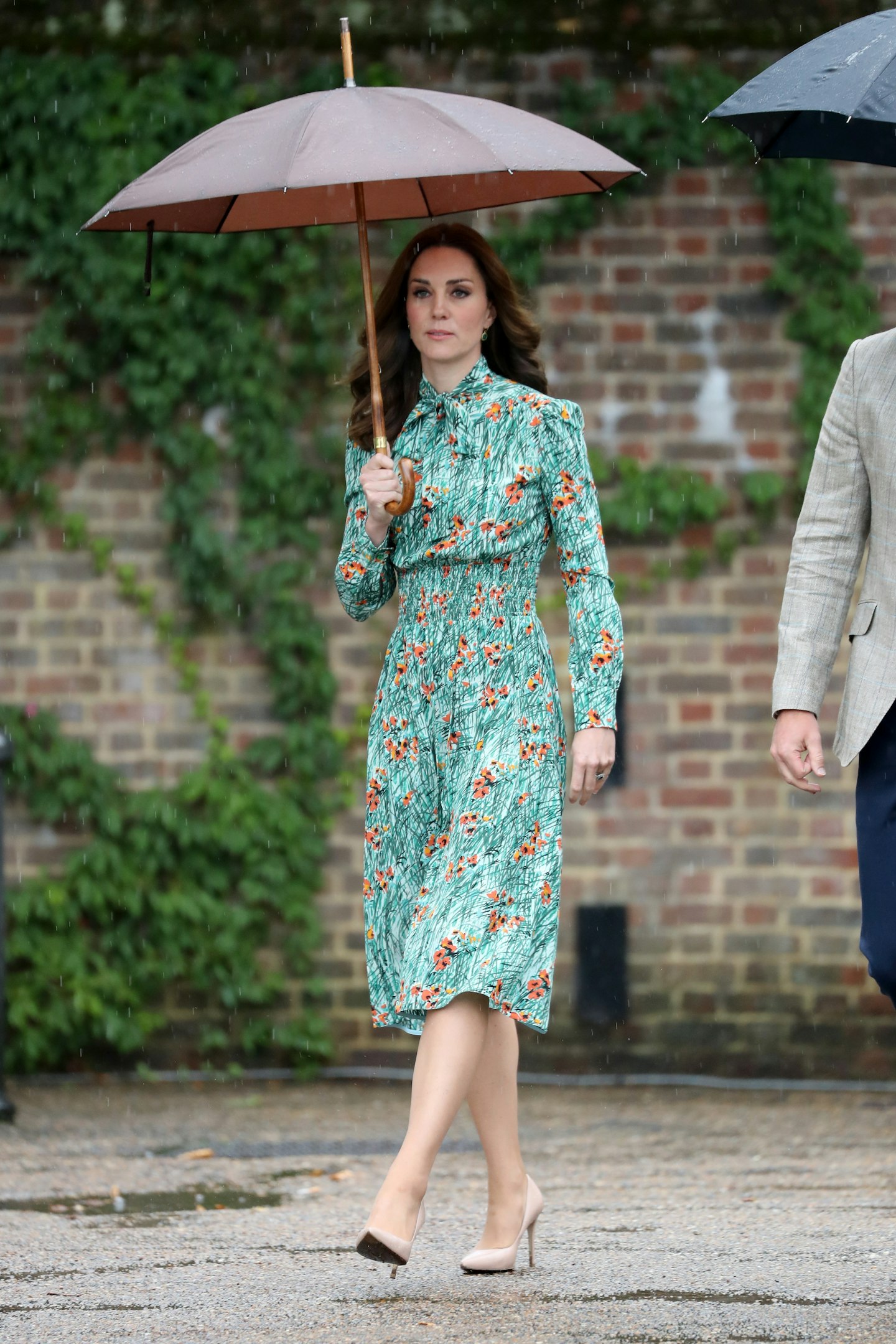 The Duchess wore a pussybow Prada dress in scribbled poppy print for a visit to Kensington Palace's Sunken Gardens, marking the 20th anniversary of Princess Diana's death