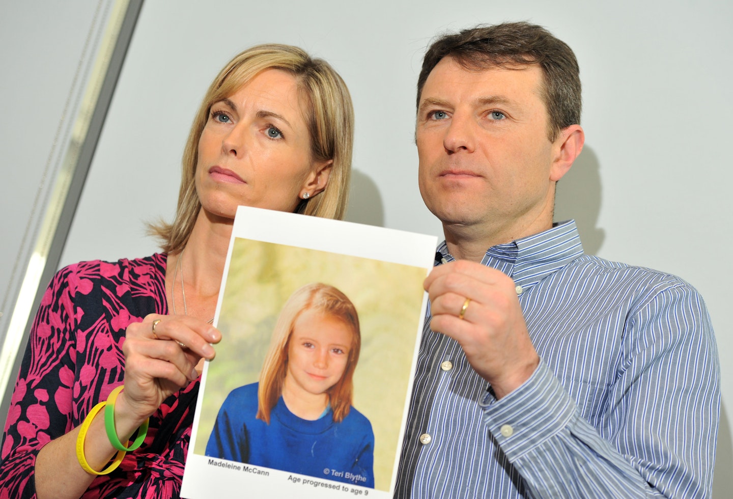 Madeleine McCann's parents Kate and Gerry hold up an aged image of their daughter