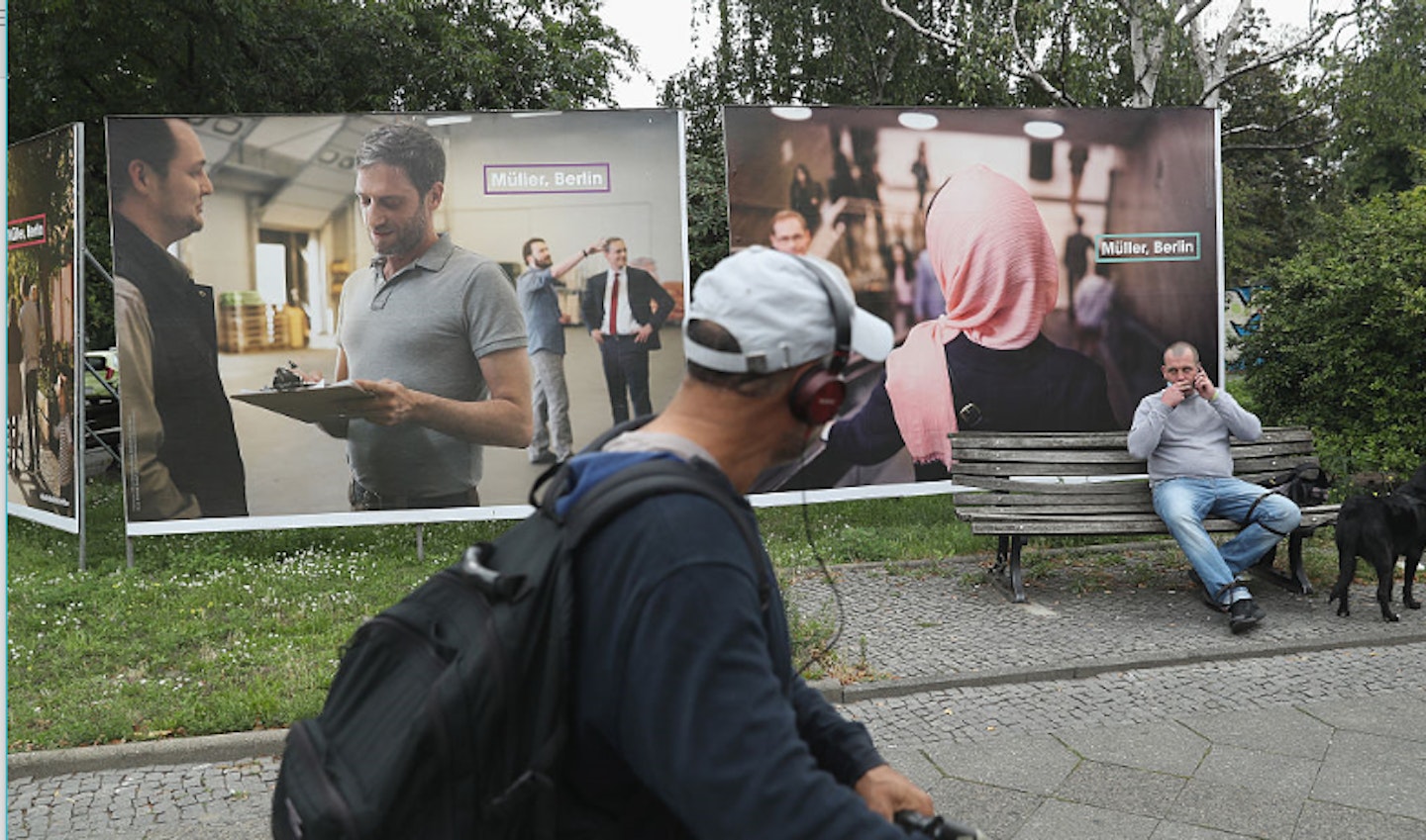 Man passing election posters in Berlin