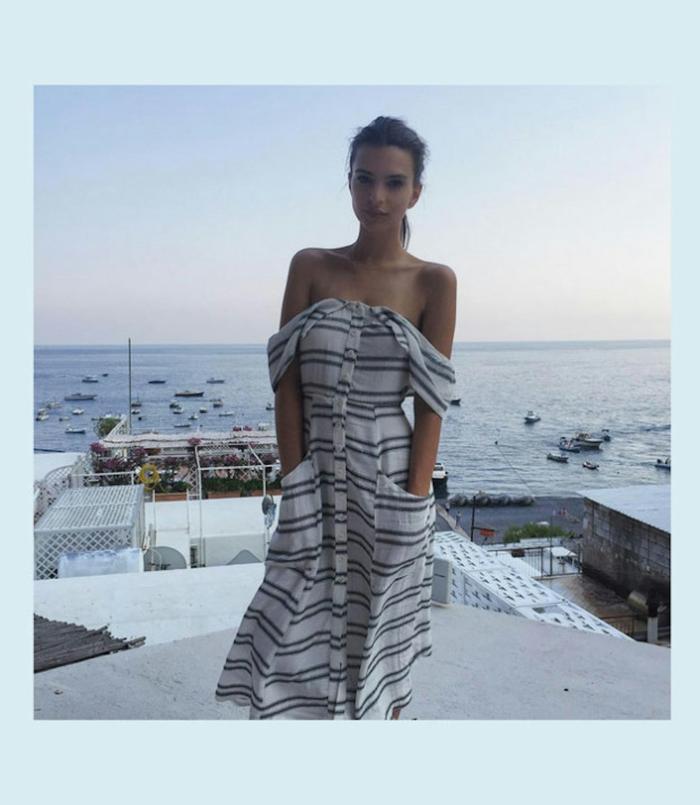 Wearing an off-the-shoulder Reformation frock