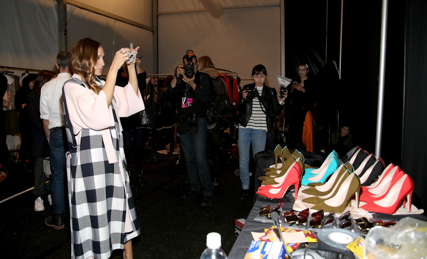 Sarah Jessica Parker takes a snap of her shoe creations [Getty]