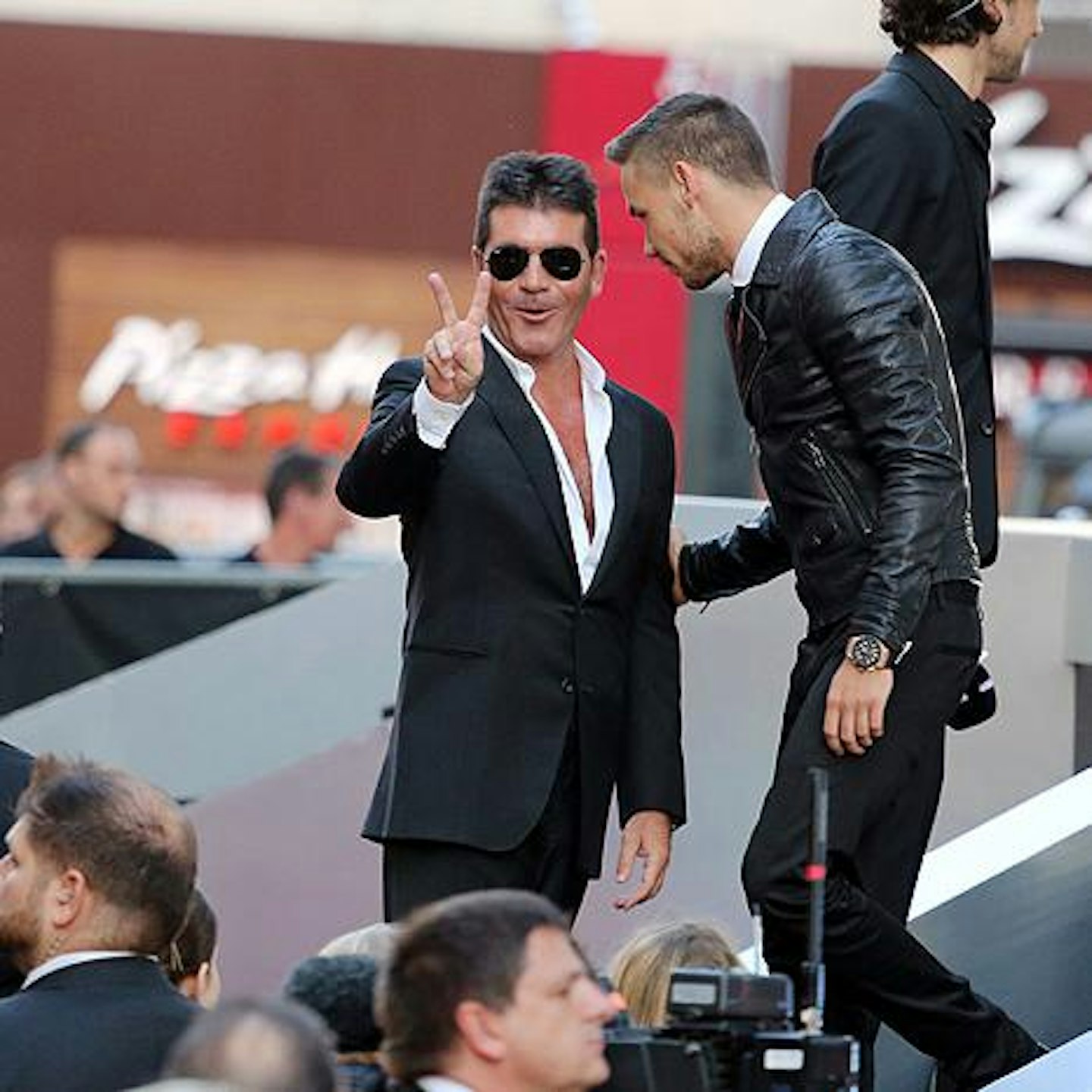 Father figure: Simon Cowell happily joked with reporters at last night's premiere of his golden boys' new film