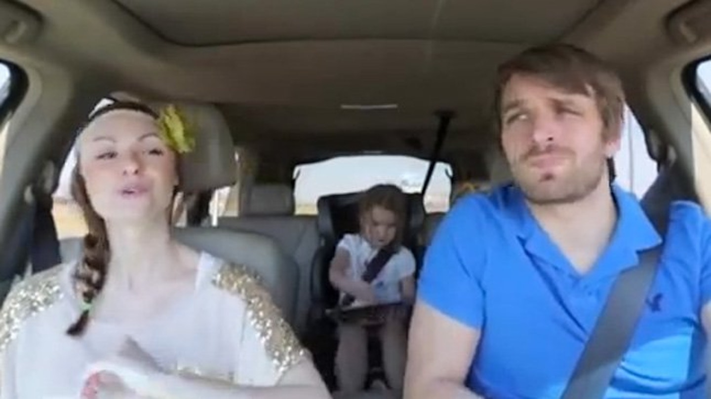 The little girl does her best to ignore her parents