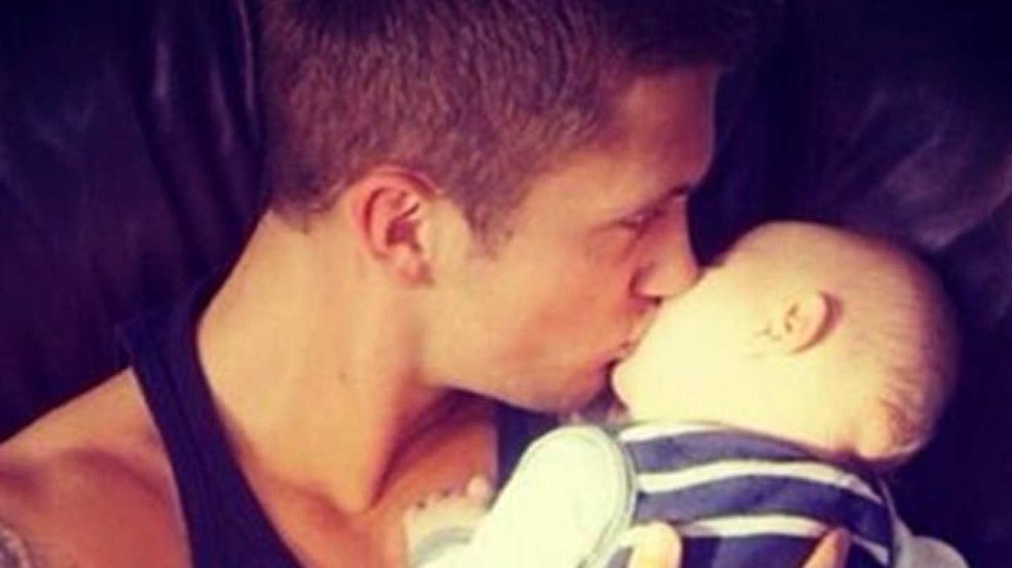 Dan lovingly plants a kiss on young Teddy