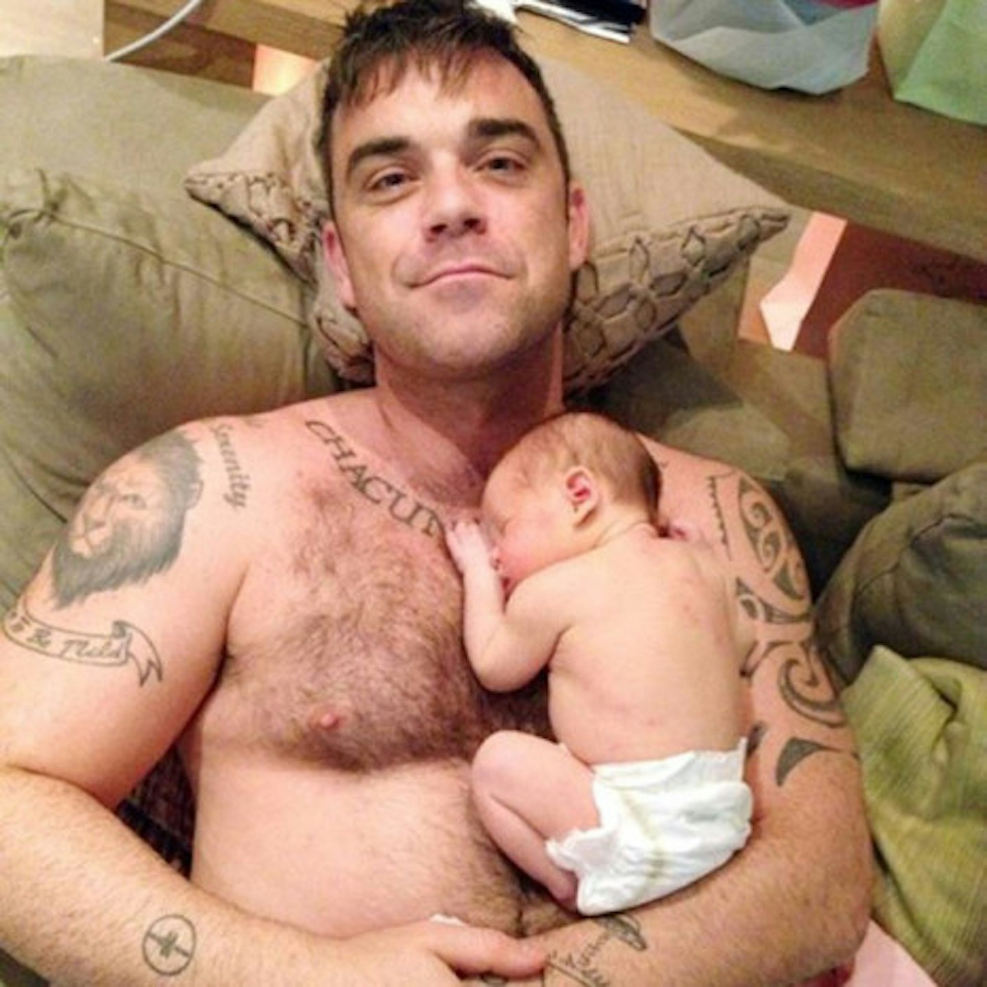 Doting daddy Robbie Williams with baby Teddy Rose