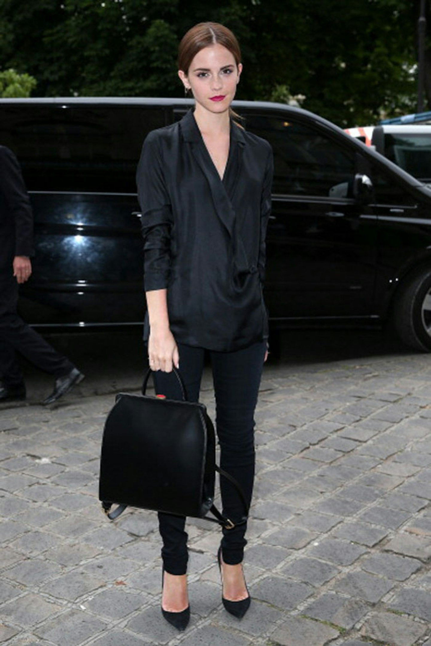 Emma Watson with her Lulu Guinness backpack at the Giambattista Valli show