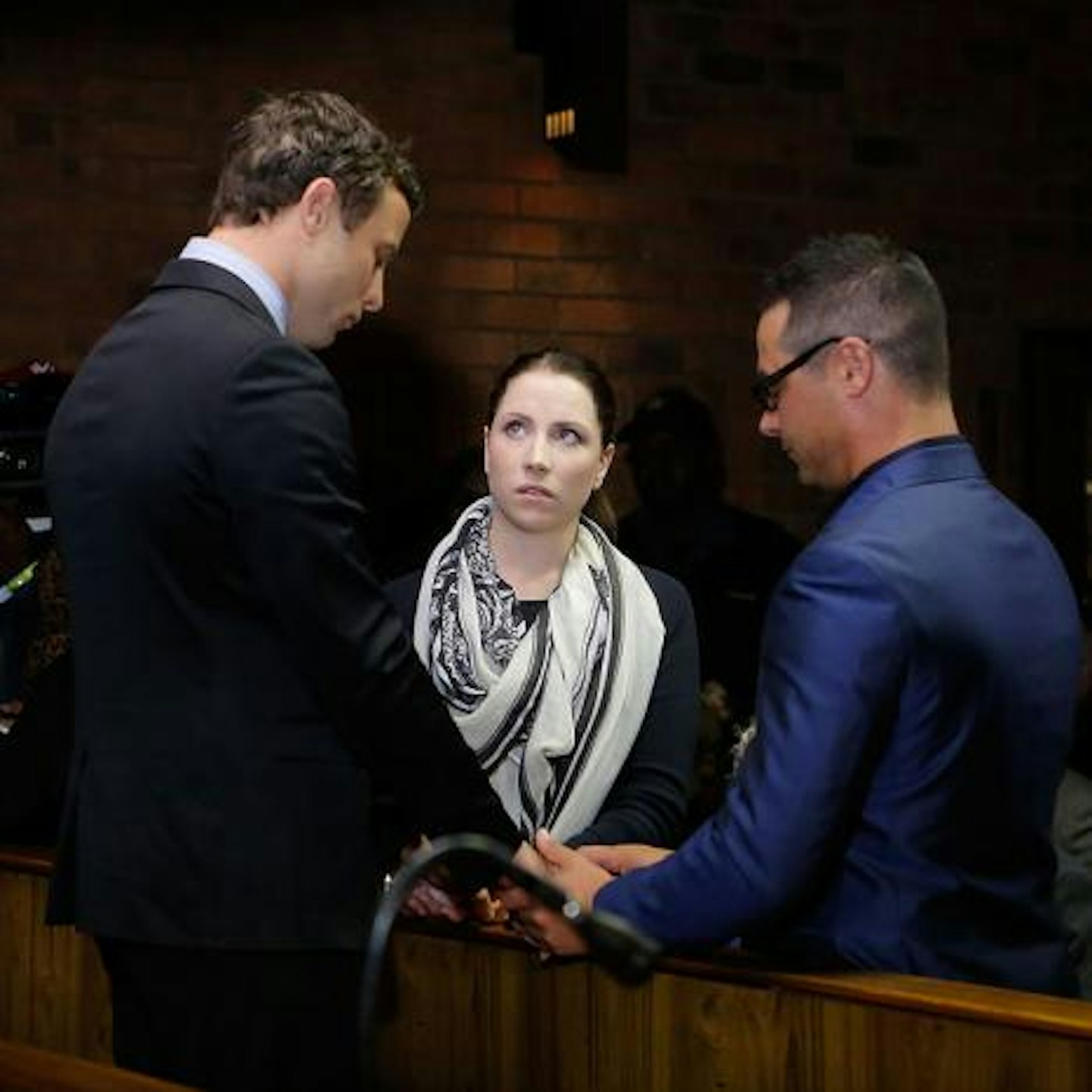 Oscar Pistorius holding hands with his siblings Aimee and Carl