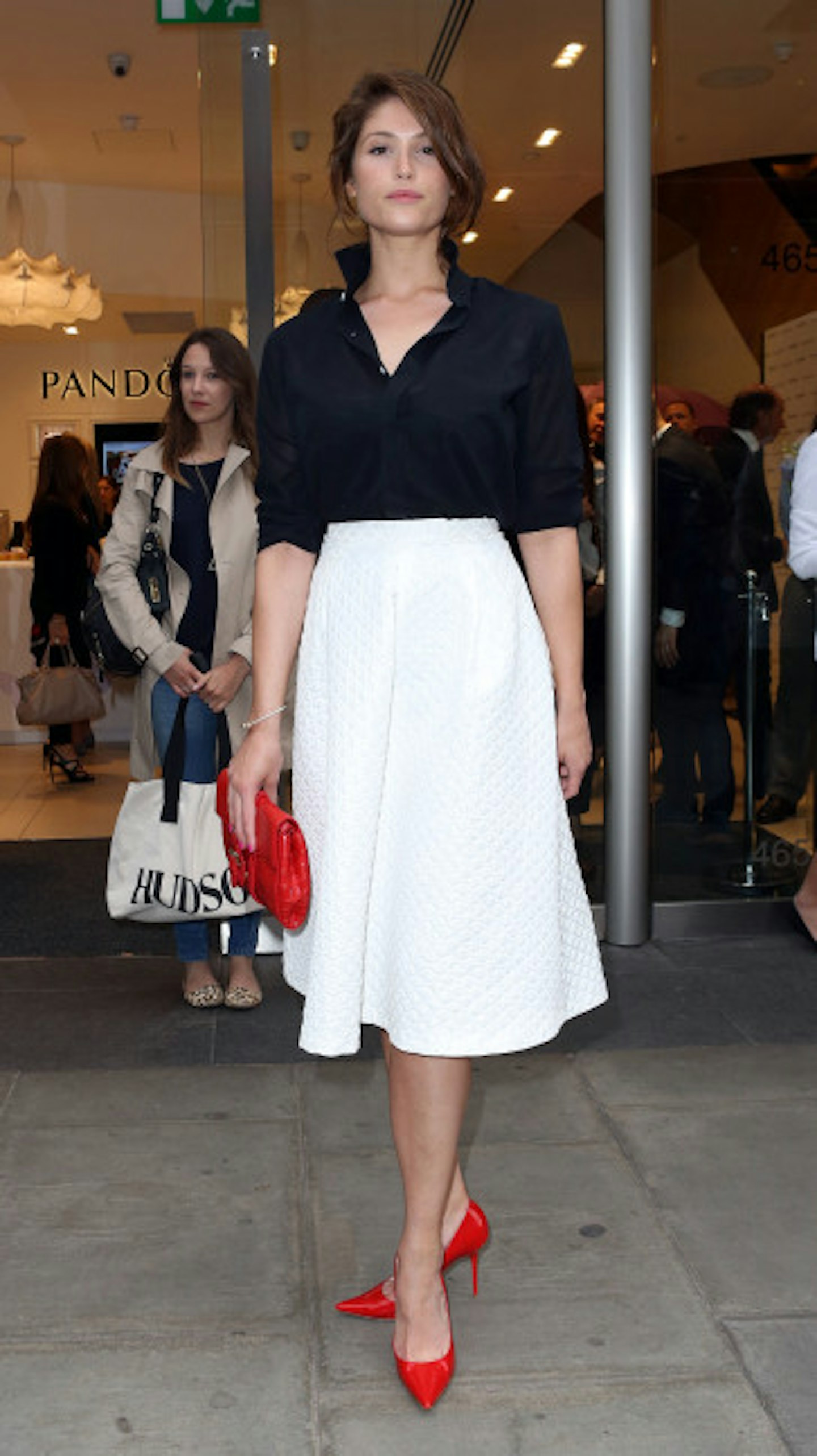 Actress Gemma Arterton gave her full skirt a nautical feel with a navy and red style up.
