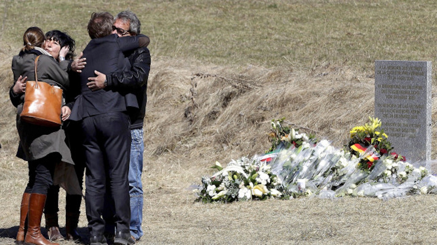 Relatives lay flowers at the site of the tragic crash